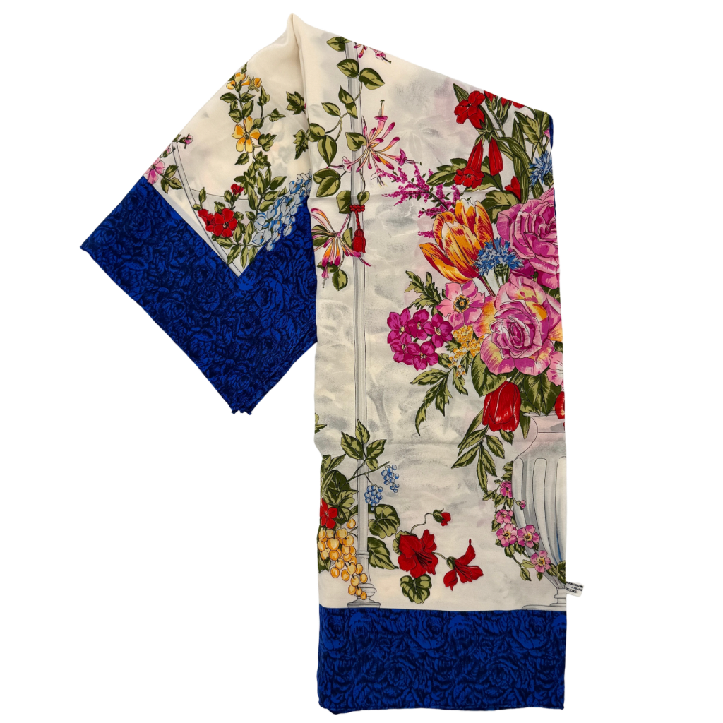 Dior silk scarf featuring an ornate multicolour floral print with a deep blue border.