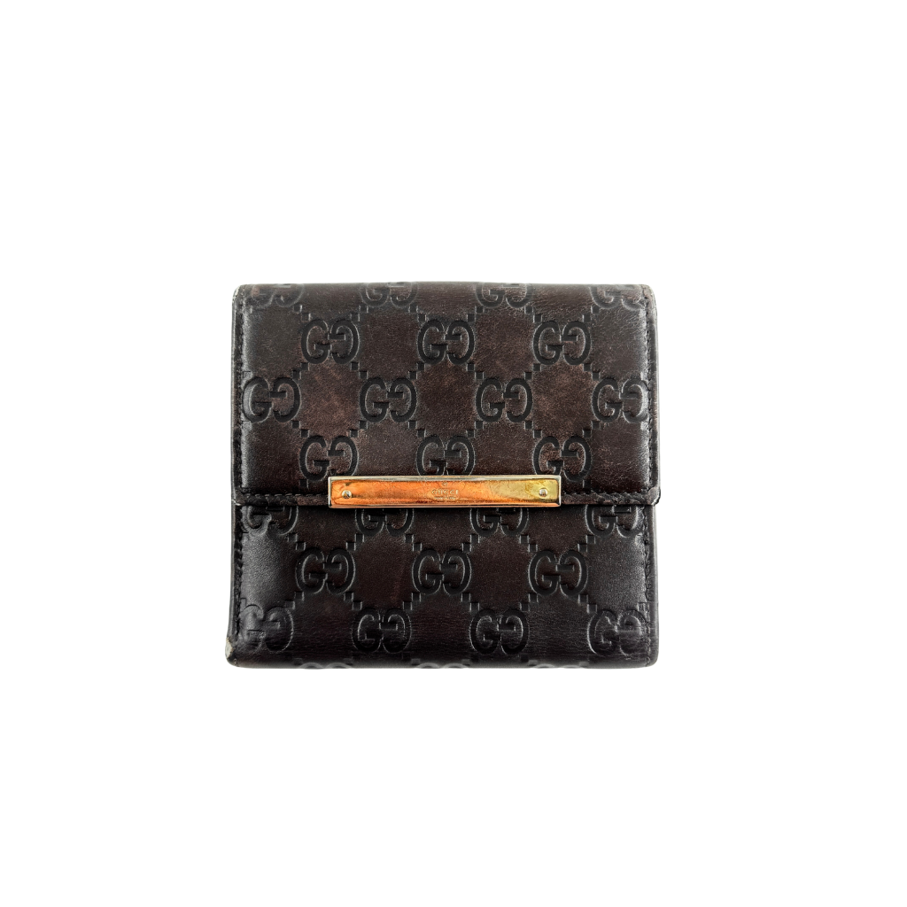 Front-facing Gucci GG Monogram Guccissima wallet in deep brown embossed leather with gold-tone bar accent.