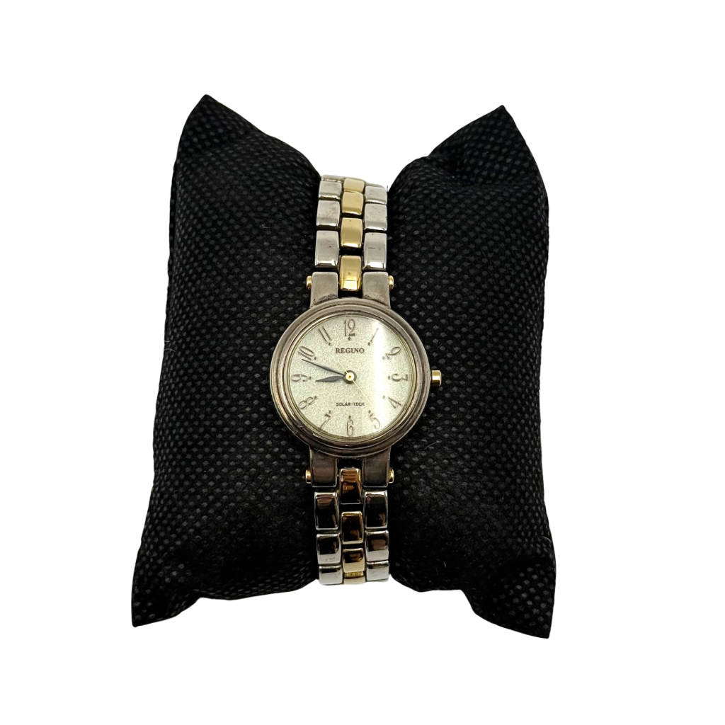 Citizen Reguno two-tone stainless steel watch in gold and silver with a round dial and linked bracelet, displayed on a black pillow.
