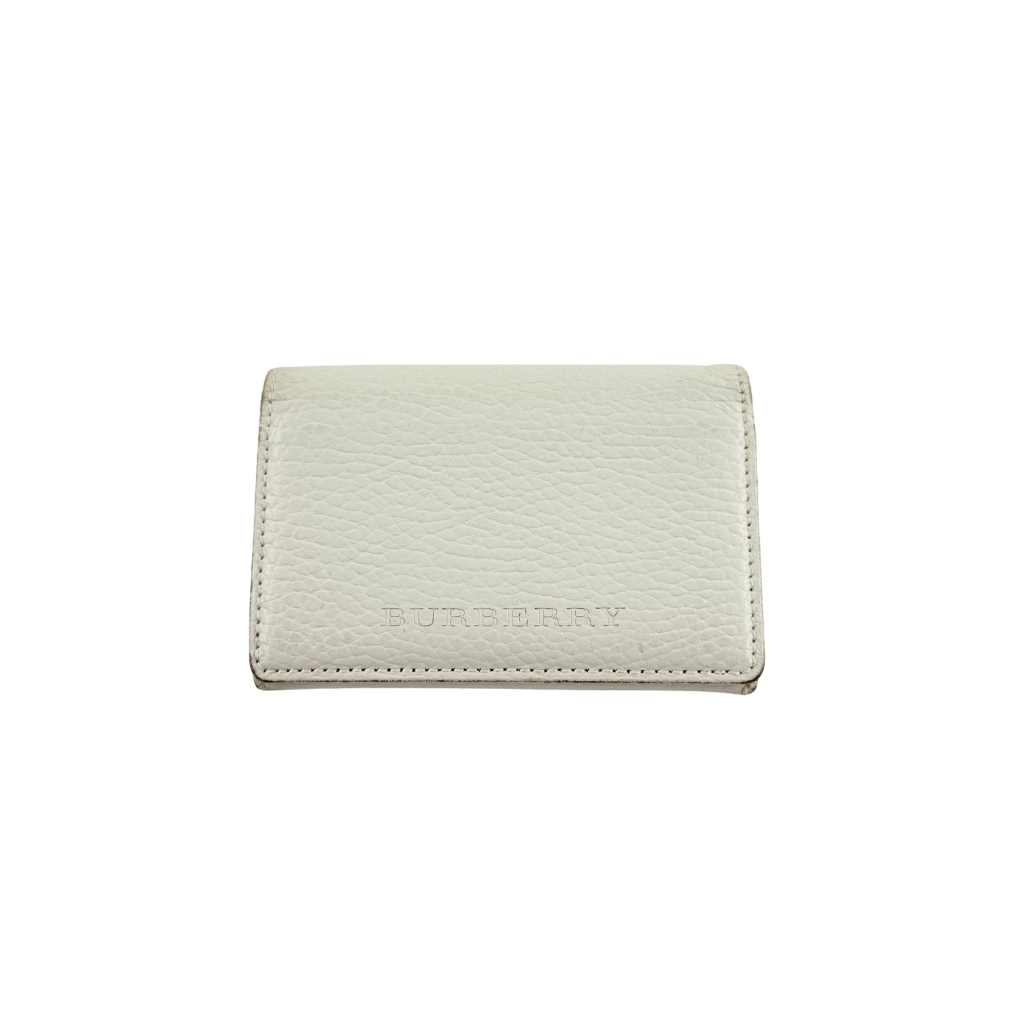 Burberry Nova Check card holder in ivory grained leather with subtle embossed logo, presented closed against a clean background.