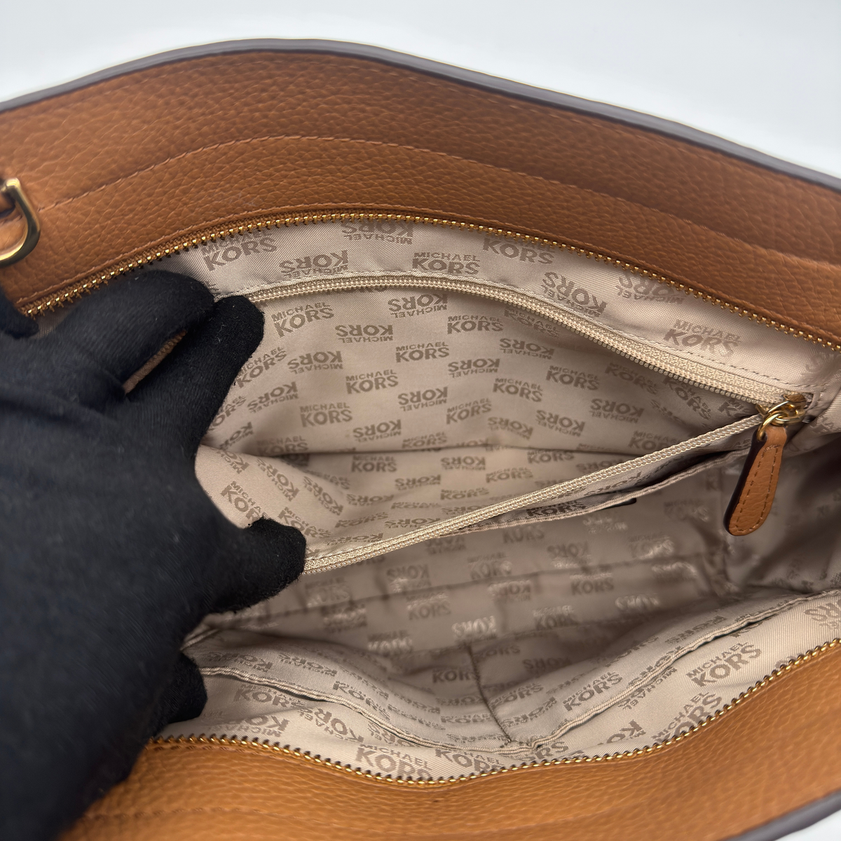 Michael Kors brown Hamilton satchel with gold-tone hardware, dual handles, and detachable strap shown against a white background.