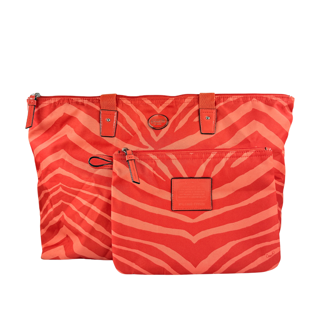 Coach Getaway Weekender tote and matching pouch in orange zebra print, with structured silhouette and bold colour.