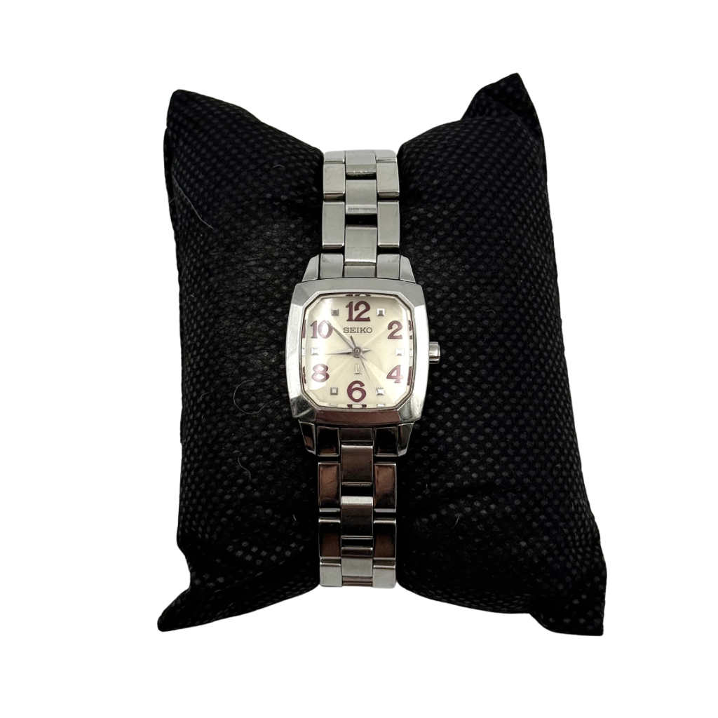 Seiko Lukia stainless steel watch with a rectangular case and silver dial presented on a cushion.