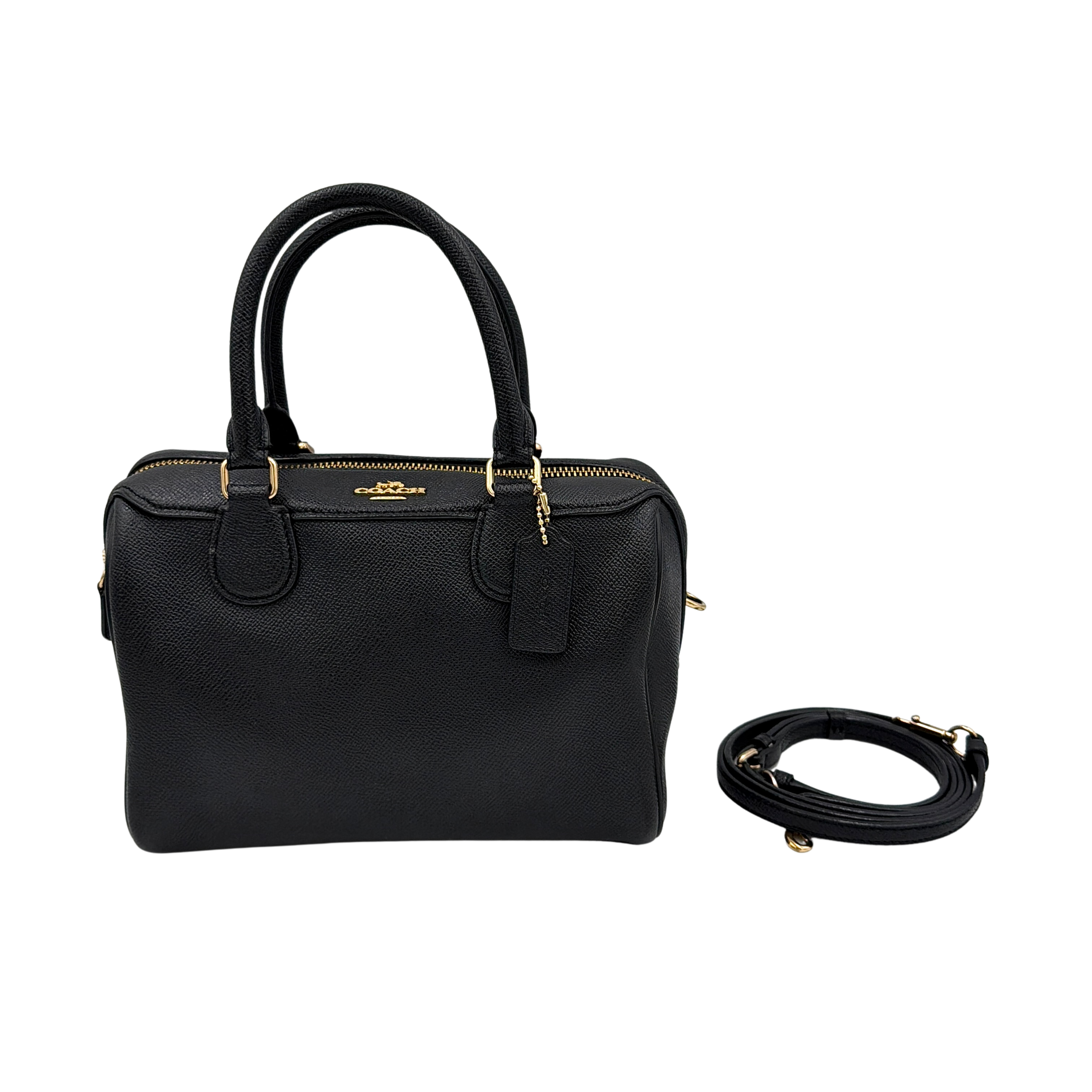 Coach Mini Bennett Boston Bag in black pebbled leather with gold hardware and detachable strap, styled against a clean backdrop.