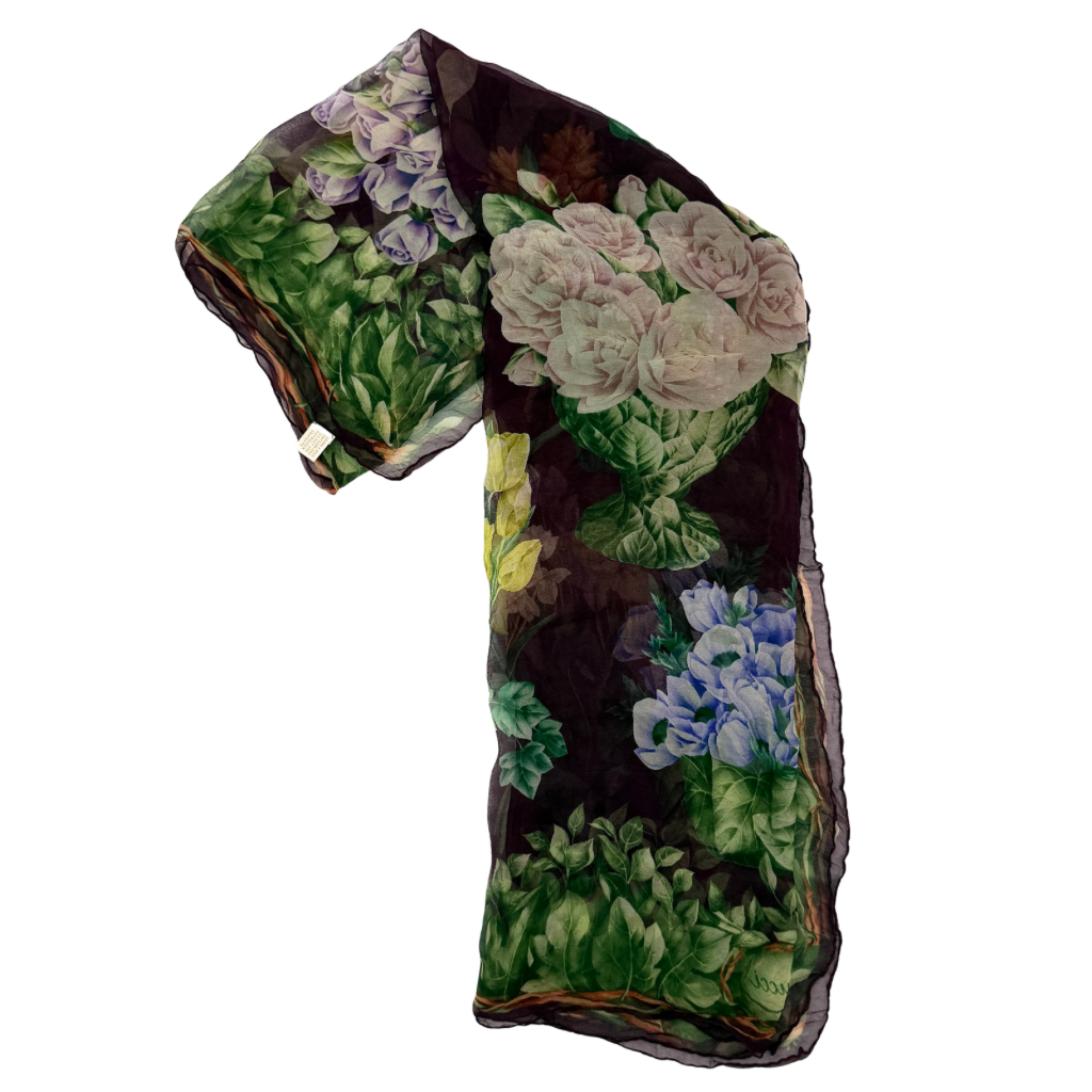 Gucci silk scarf adorned with artistic multicolour floral bouquets and leafy green border, elegantly draped to showcase its lightweight, sheer texture.