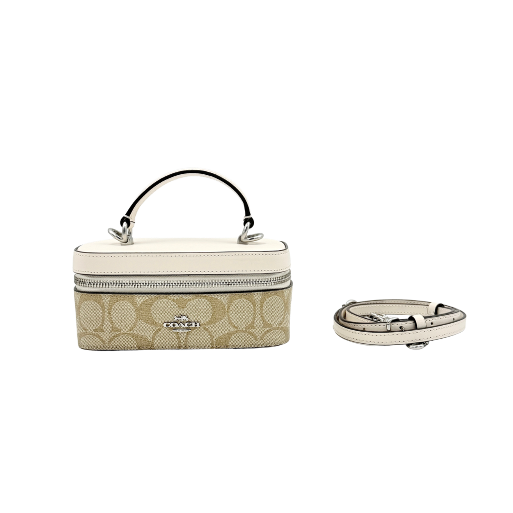 Coach 2Way Signature Train Case in beige and white canvas with a leather top handle and detachable strap, shown with silver zip hardware.