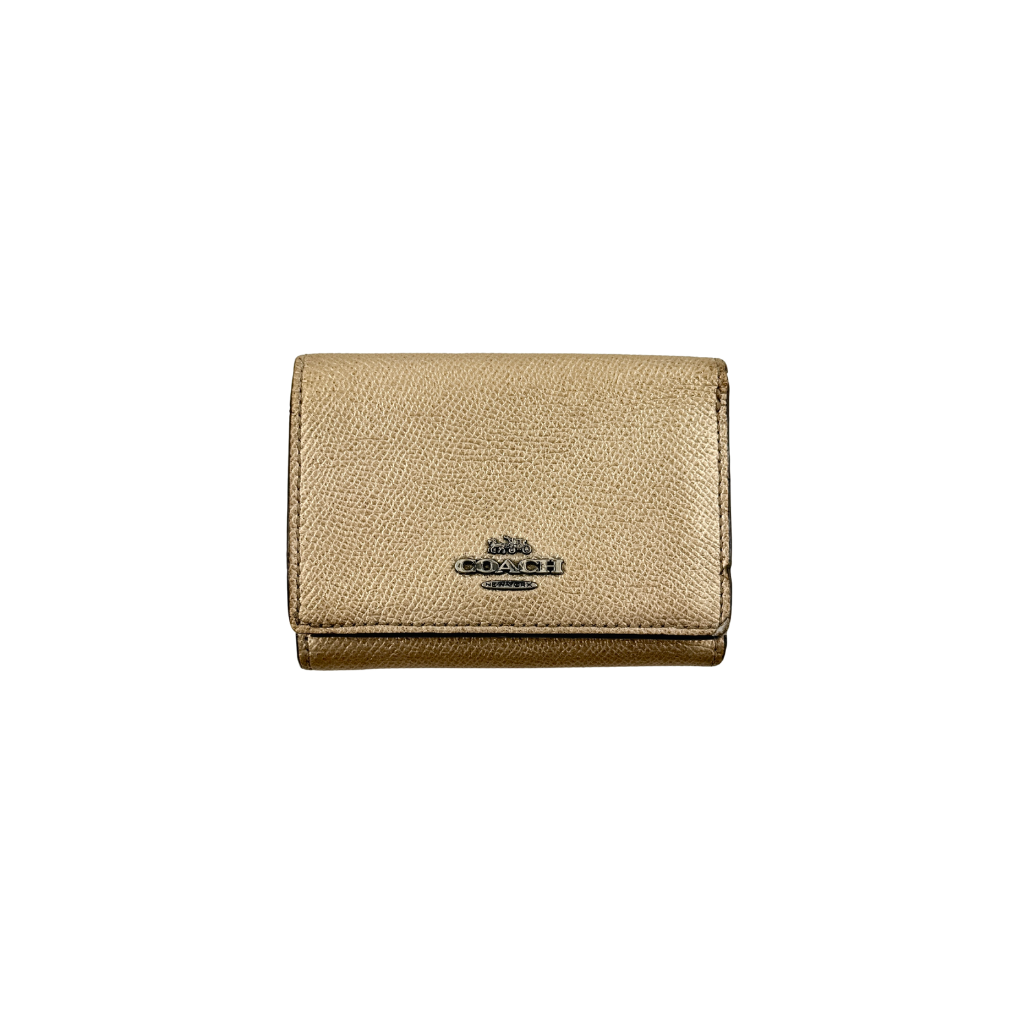 Coach metallic gold small flap wallet with silver logo plaque and crosshatch textured leather.