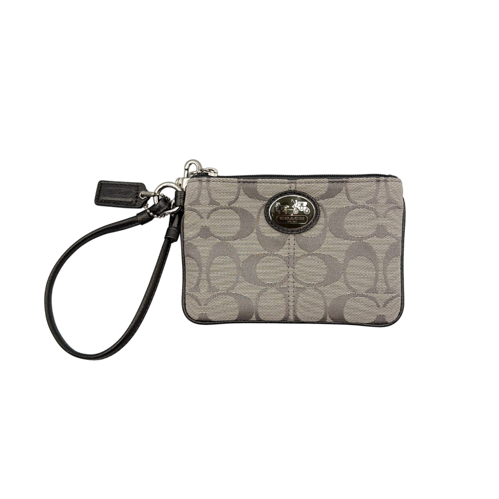 Coach Signature Canvas Corner Zip Wristlet in grey with monogram print, silver oval logo plaque, and black leather wrist strap.