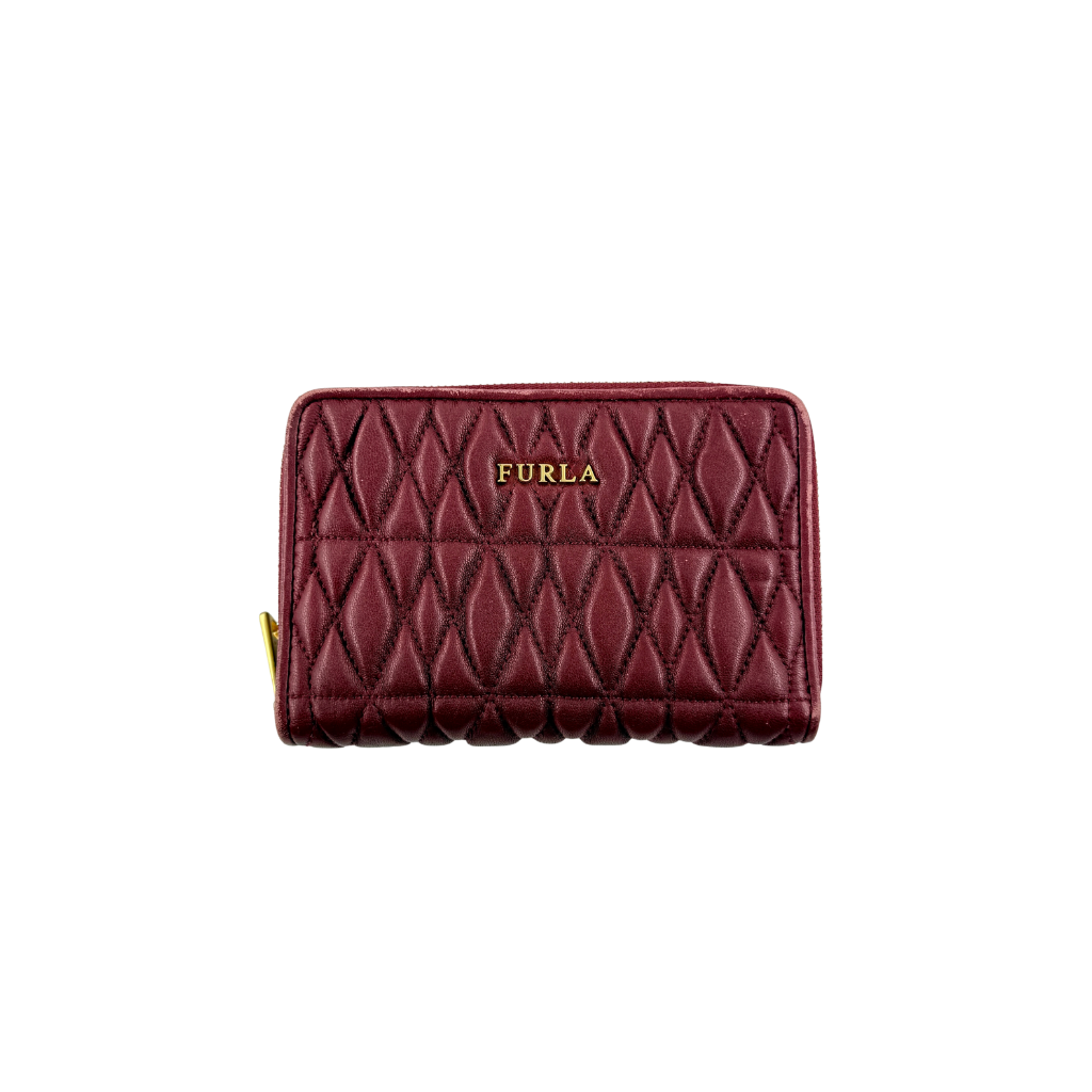 Furla quilted Cometa zip around wallet in deep burgundy leather with gold-tone hardware and diamond stitching.