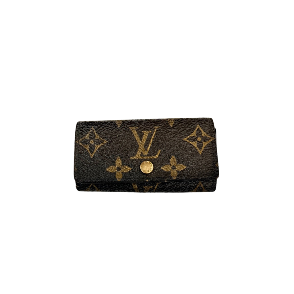 Louis Vuitton monogram key case in brown with gold-tone snap closure and classic LV pattern on coated canvas.