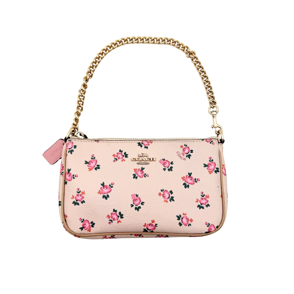 Coach Nolita 19 pink shoulder bag in floral print with gold chain handle, photographed against a white background.