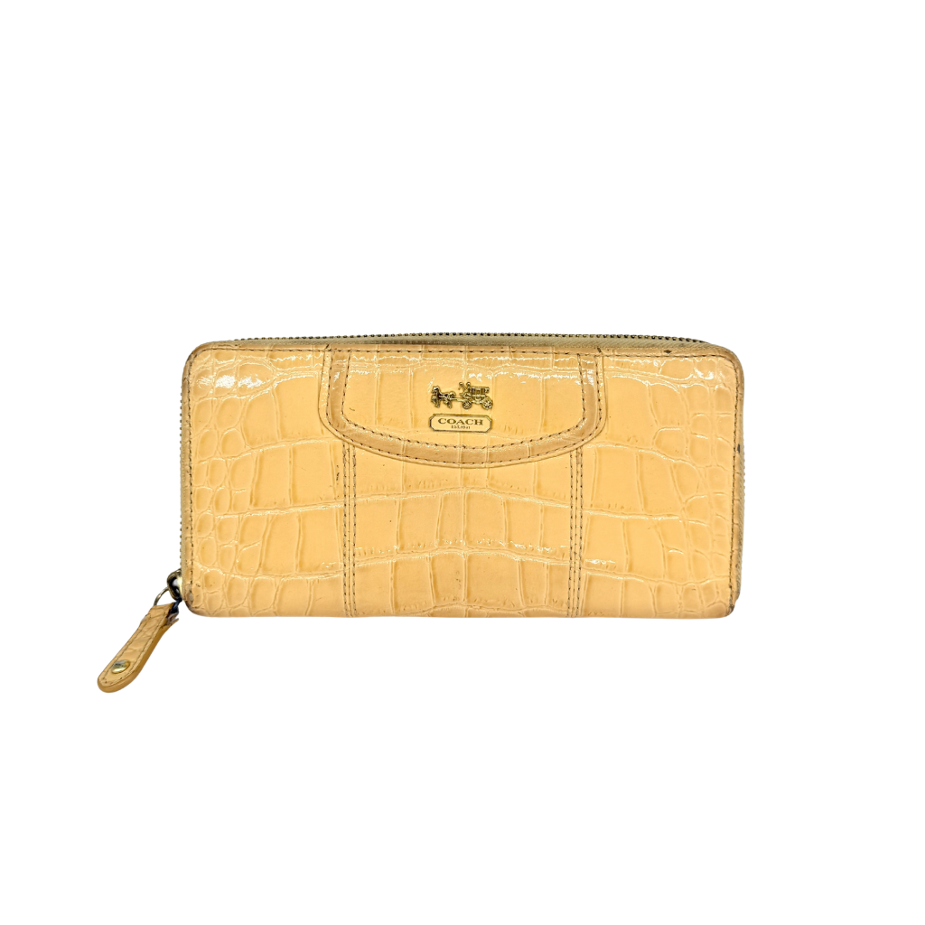 Coach beige croc-embossed zip around wallet with gold hardware and a sleek, structured silhouette.