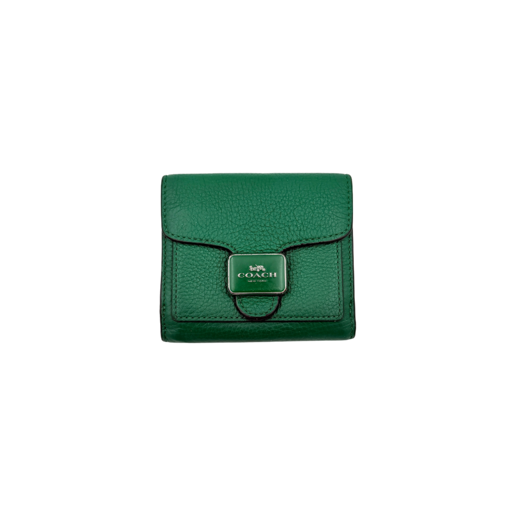 Coach Pepper Leather Wallet in emerald green pebbled leather with a front flap and enamel logo plaque, displayed neatly against a white background.