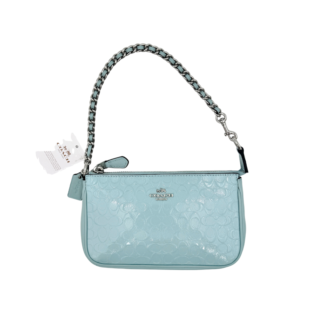Coach Nolita 19 small shoulder bag in light blue embossed patent leather with silver-tone chain strap shown against a white background.
