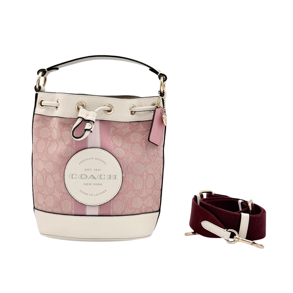 Coach Signature Dempsey 19 bucket bag in pink and white canvas with white leather trim and detachable strap.