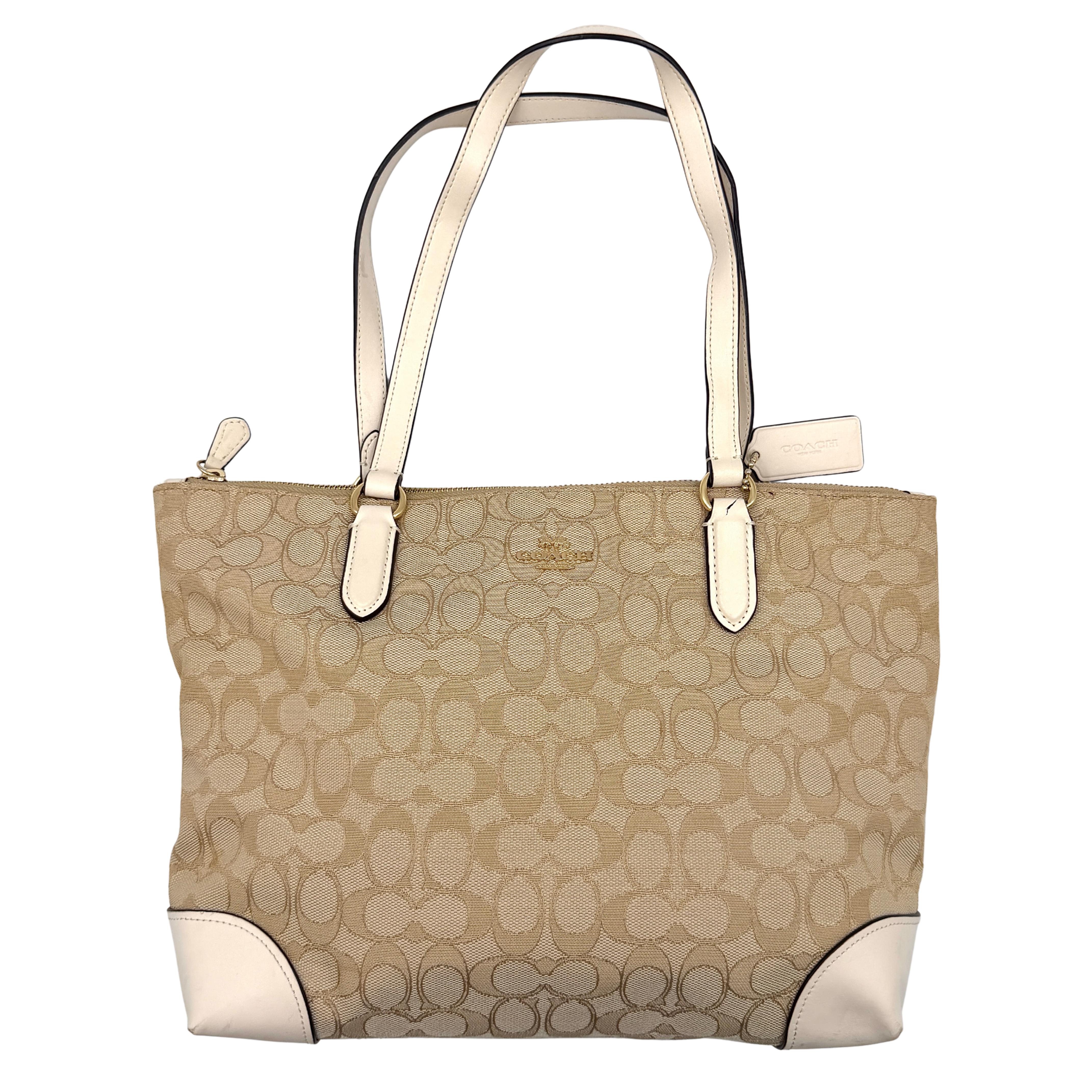 Coach Signature Zip Top Tote Bag in beige canvas with white leather trim and double handles, featuring the signature monogram print.