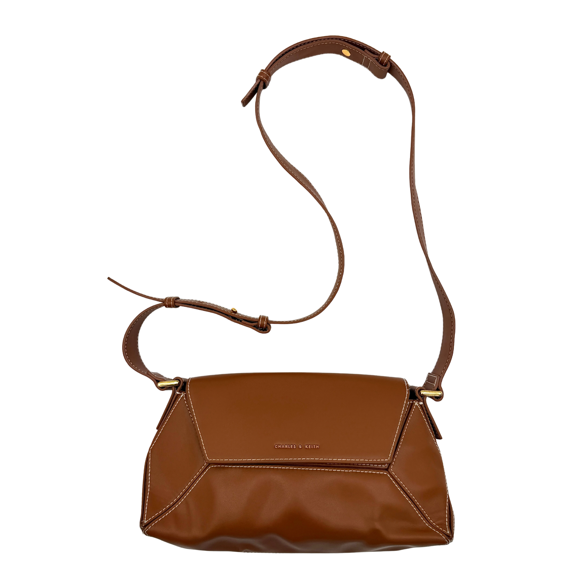 Charles & Keith Nasrin Geometric Crossbody Bag in brown faux leather with angular stitching, gold-tone hardware, and adjustable strap.