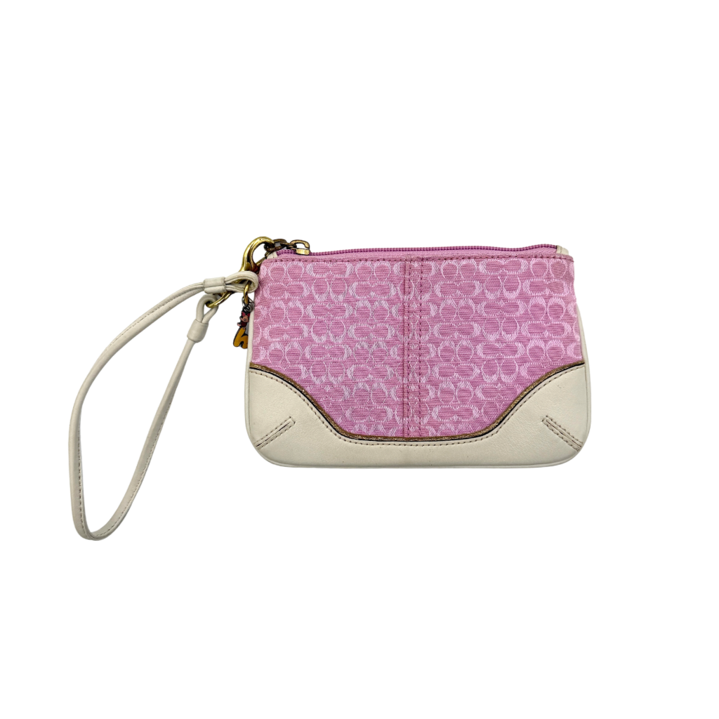 Coach Y2K Signature Canvas Wristlet in pink with white leather trim and a whimsical Piglet charm detail.