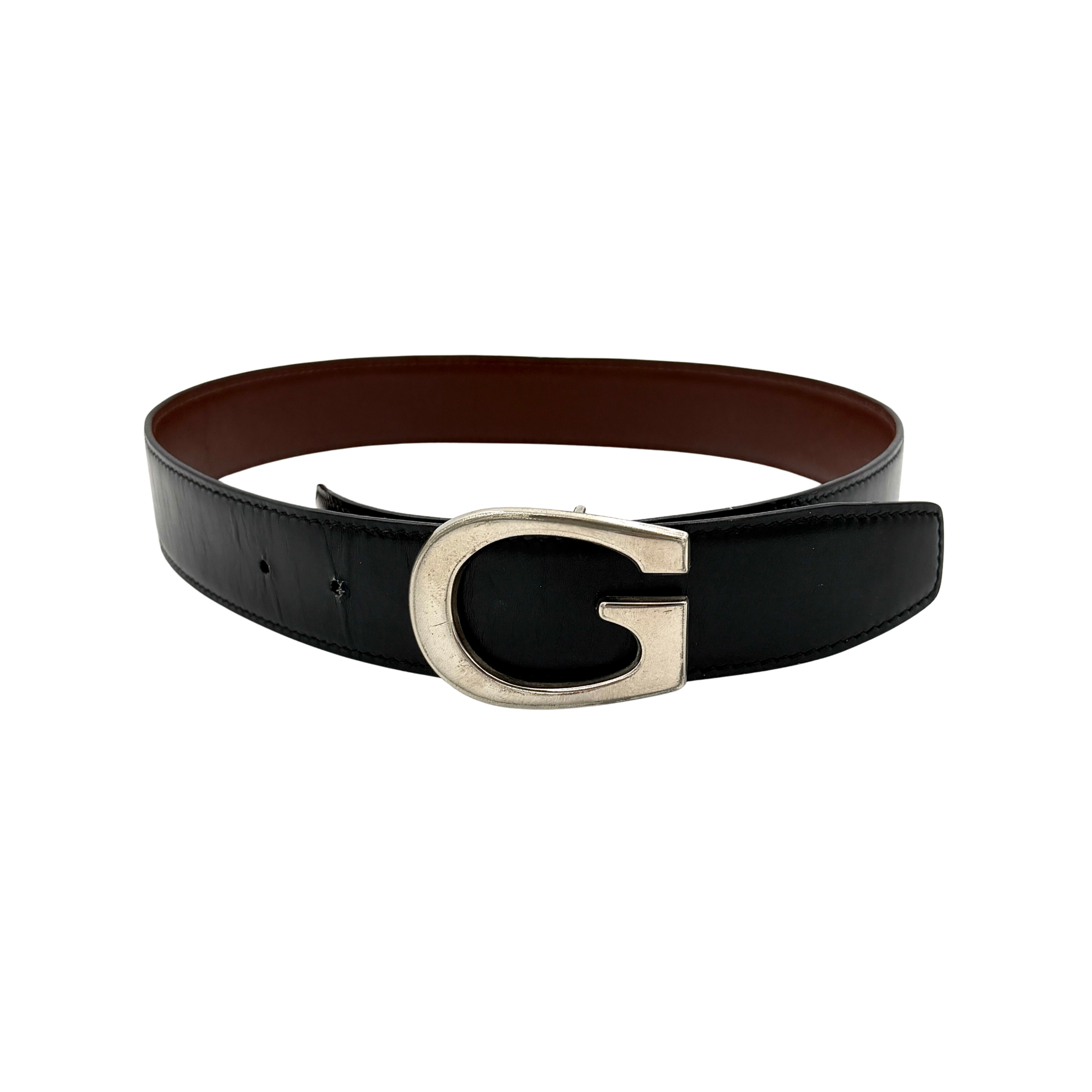 Gucci black leather belt with an oversized silver metal G logo buckle displayed in a curved profile.