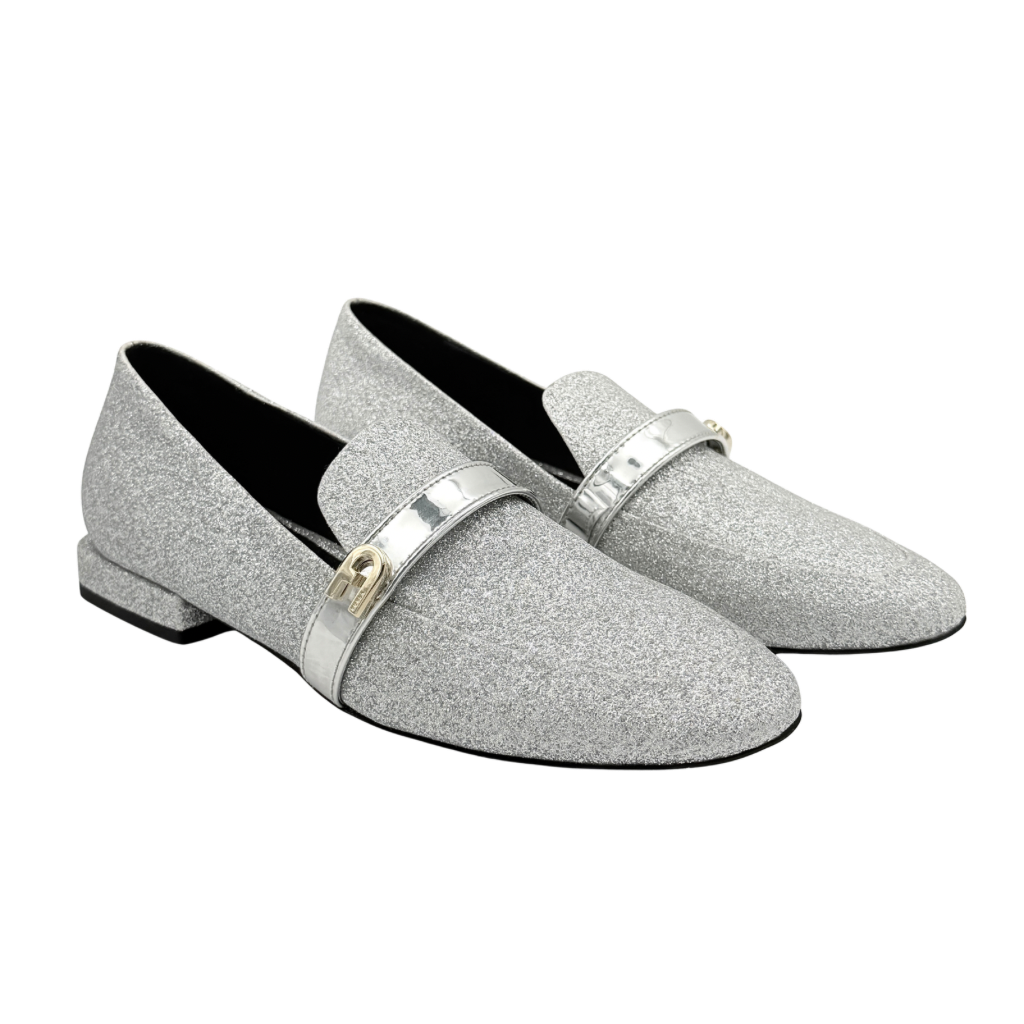 Furla 1927 T.20 loafers in silver microglitter with metallic strap and gold-tone detail, displayed in a three-quarter view.