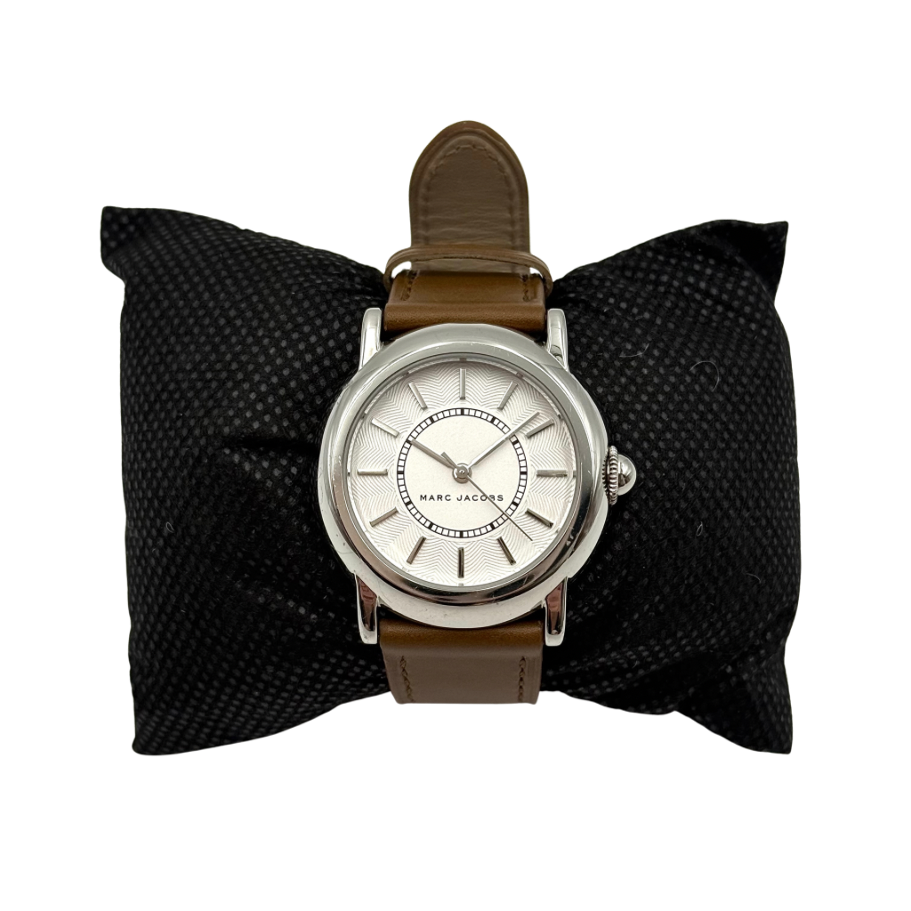 Marc Jacobs Courtney watch with silver stainless steel case and brown leather strap shown on a black cushion.