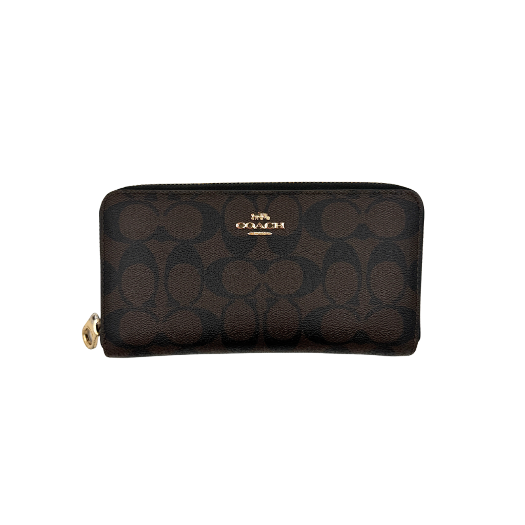 Coach Signature Canvas long wallet in brown monogram with gold zip and logo, shown from the front against a clean background.
