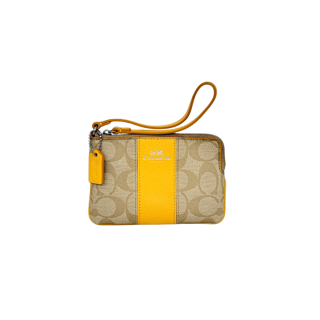 Coach Signature Stripe Corner Zip Wristlet in beige canvas with bold yellow leather stripe, silver hardware, and wrist strap displayed on a white background.