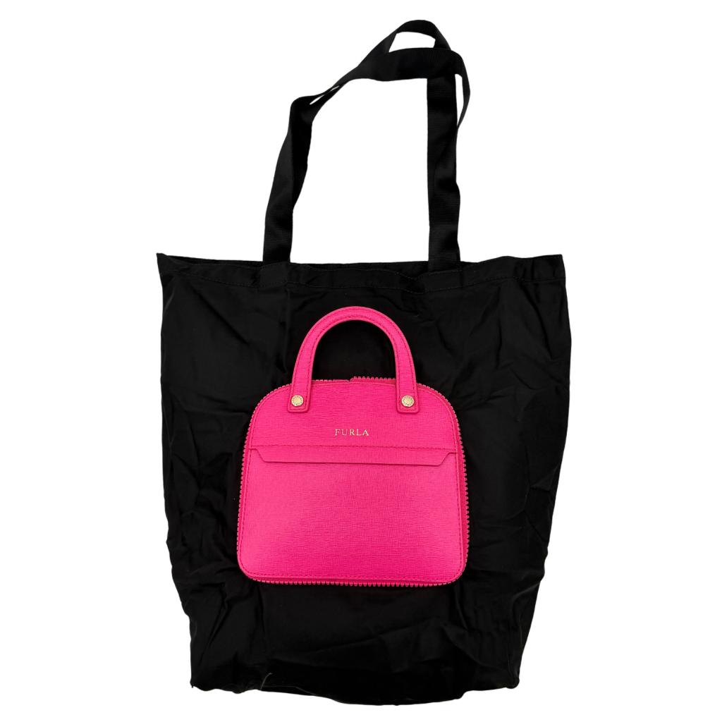 Furla black nylon tote bag with a bold pink zip pouch detail, styled as an exterior pocket, displayed flat to showcase its silhouette.