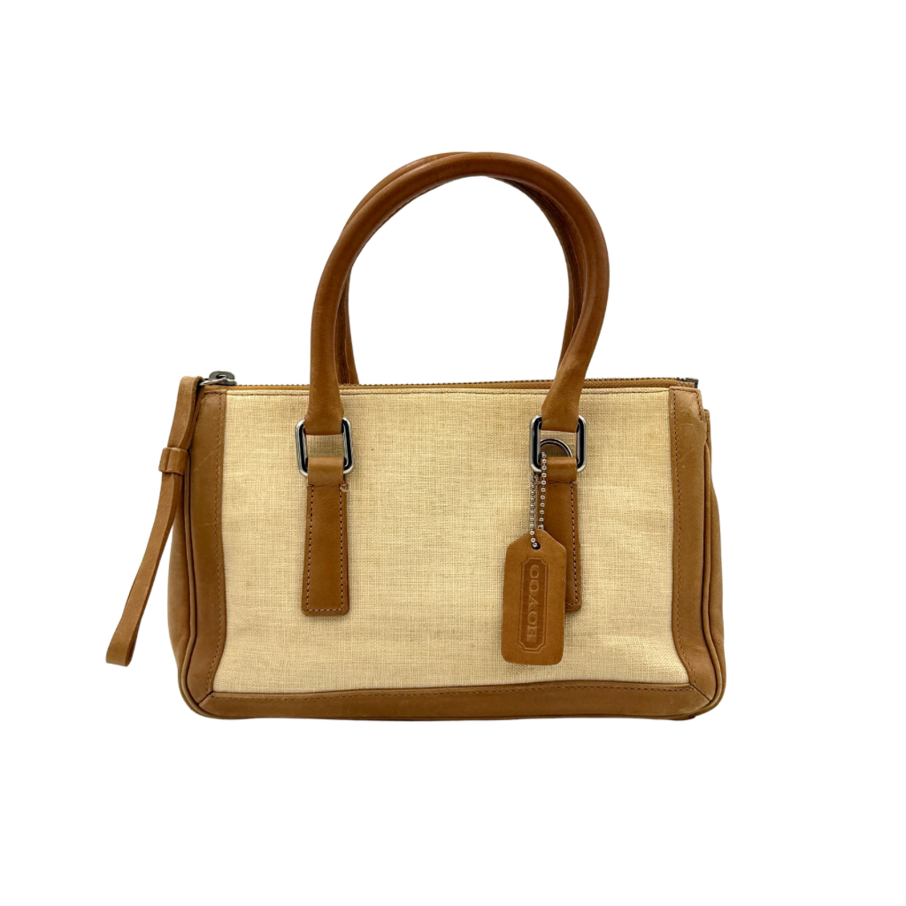 Coach Bonnie Legacy Satchel in beige canvas with caramel leather trim, structured silhouette and dual rolled handles.