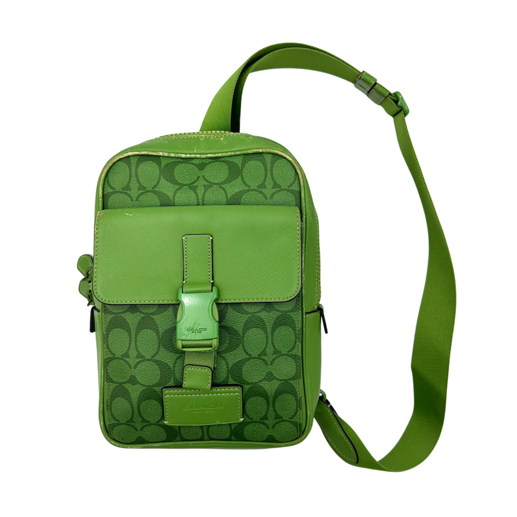 Coach Signature Canvas Track Pack Crossbody Bag in vibrant green with tonal green hardware and adjustable strap set against a clean background.