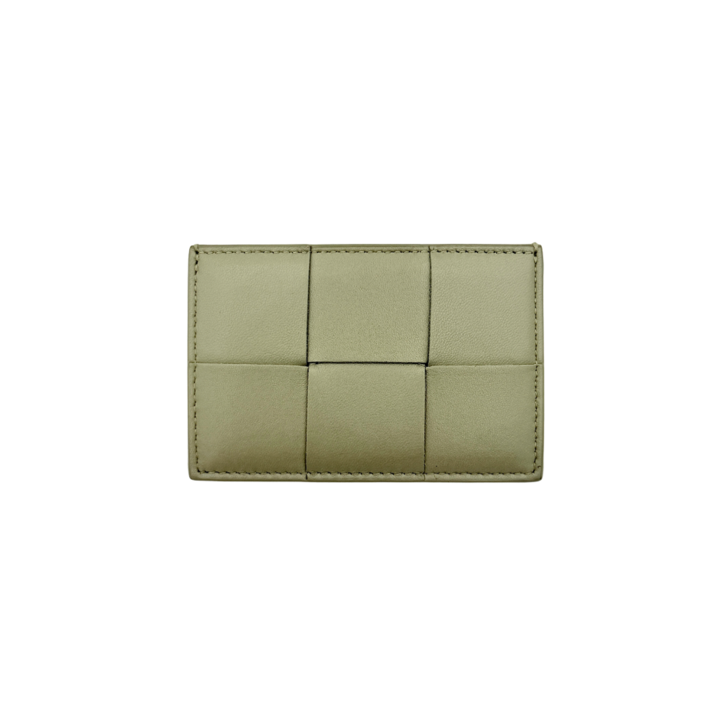 Bottega Veneta Cassette card holder in travertine green leather with signature padded Intrecciato weave, photographed against a white background.