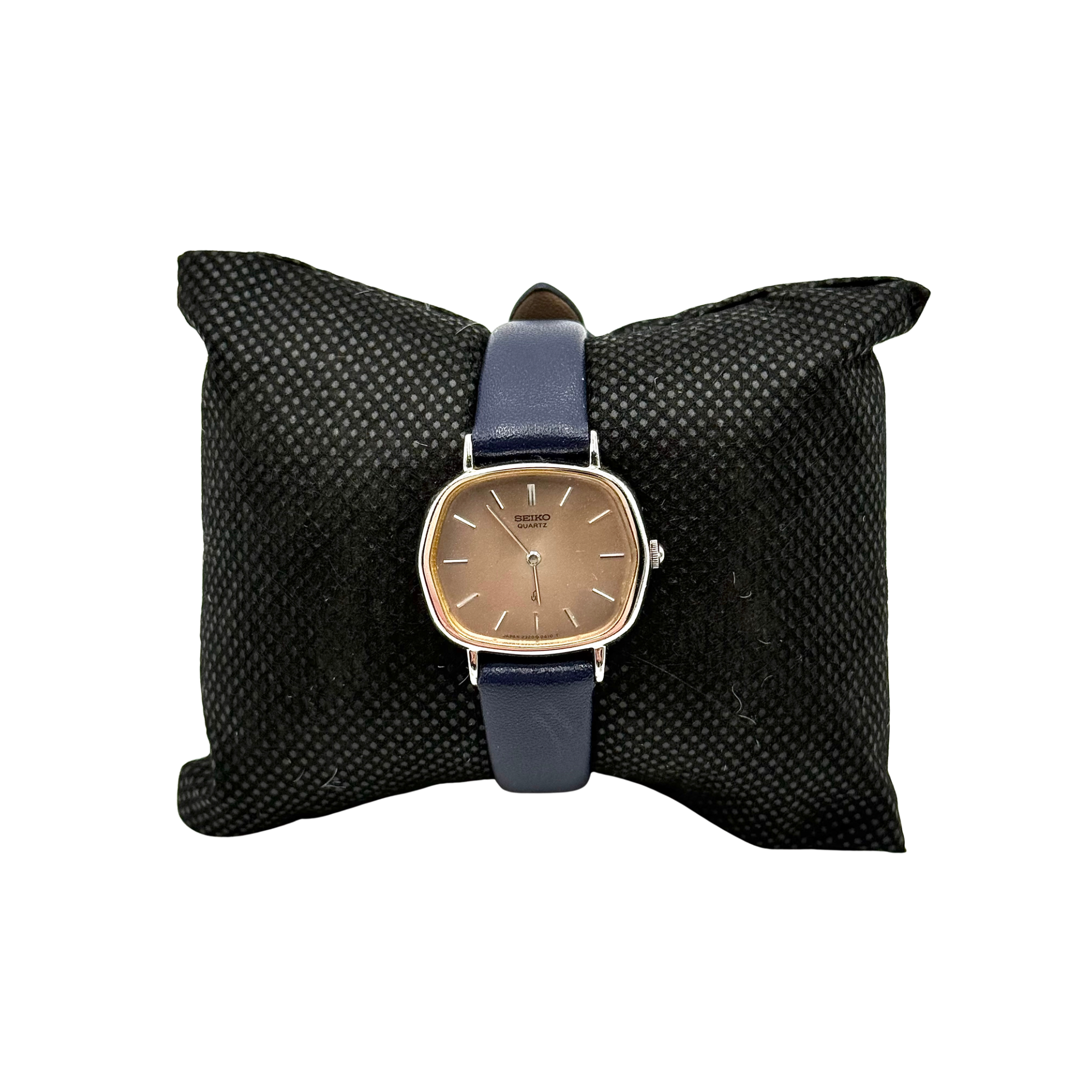 Seiko Quartz 2320-5270 with a square stainless steel case, copper dial, and navy blue leather strap displayed on a textured cushion.