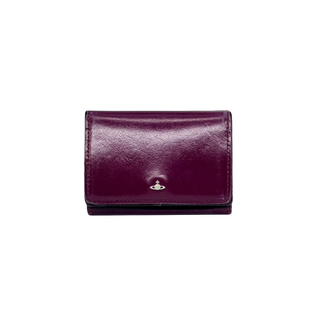 Vivienne Westwood Signature Orb Wallet in glossy purple leather with silver orb emblem on the front flap.