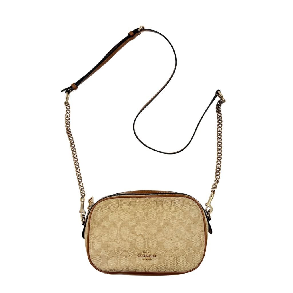 Coach Signature Isla Chain Crossbody Bag in beige and brown jacquard with caramel leather trim and gold-tone chain strap.