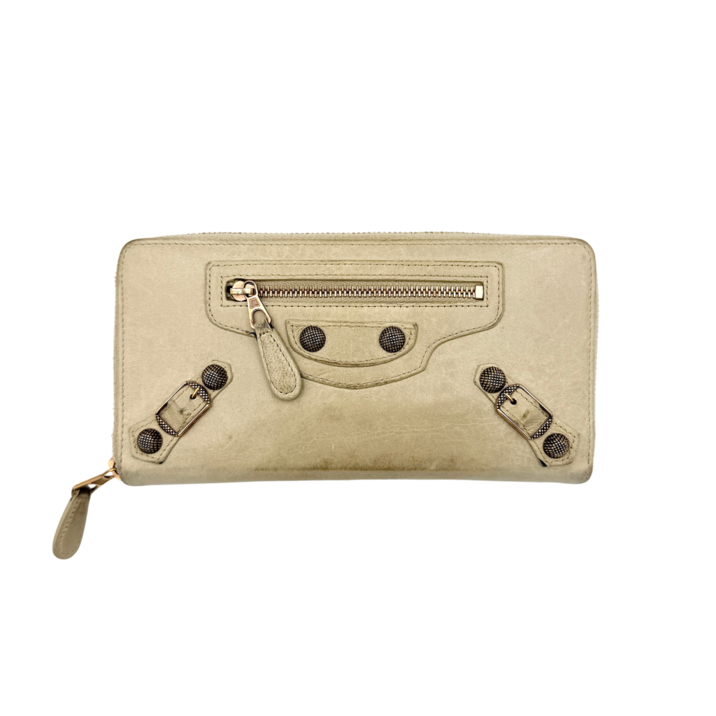 Balenciaga Motorcycle Studded Long Wallet in beige leather with signature studs and front zip pocket, displayed against a clean background.