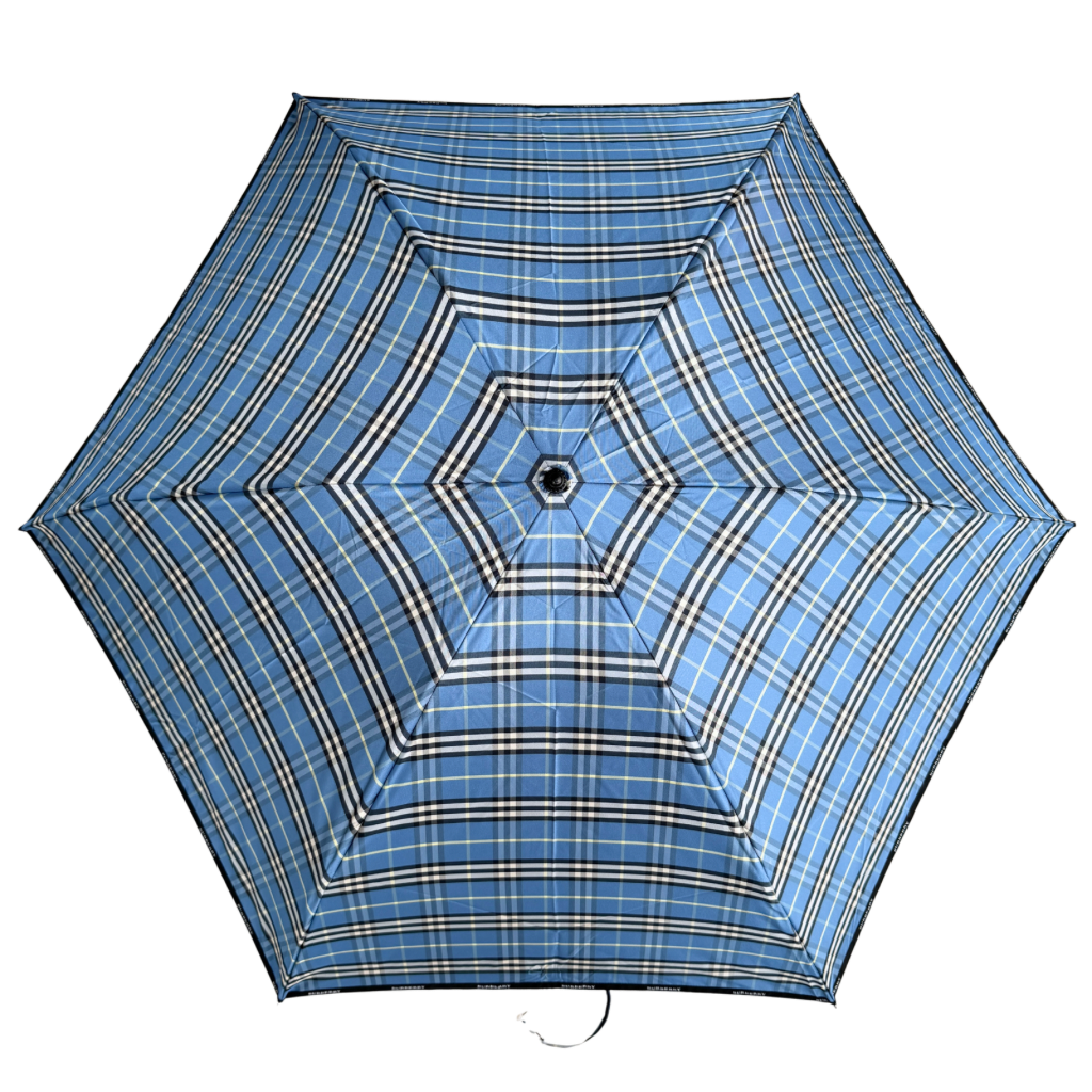 Burberry folding umbrella and matching pouch in blue Nova Check plaid, perfectly folded to showcase its classic pattern and refined finish.