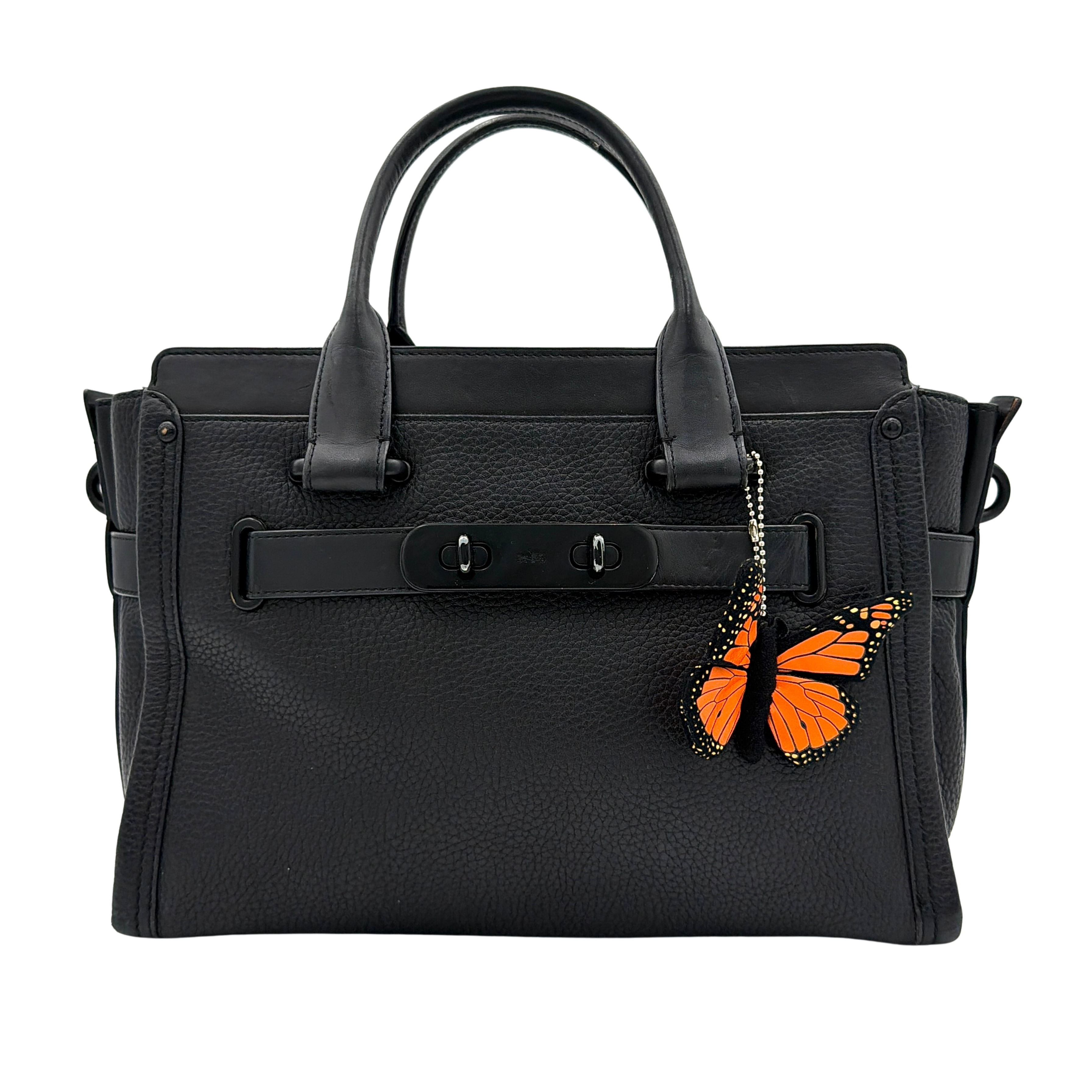Coach Swagger Carryall handbag in black pebbled leather with matte black hardware and a vibrant orange butterfly charm.