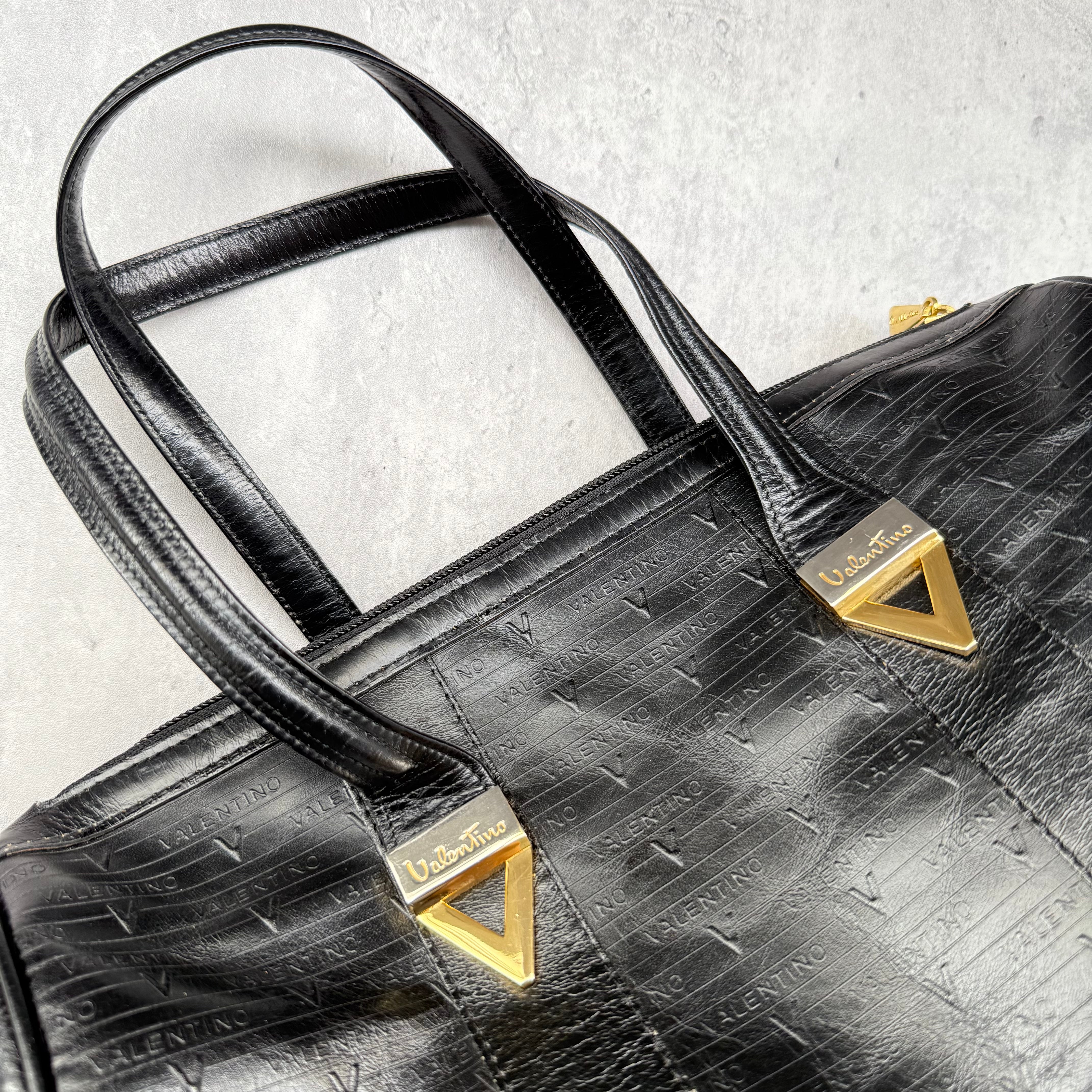 Valentino Monogram Boston Bag in glossy black leather with gold triangle logo plates and top handles