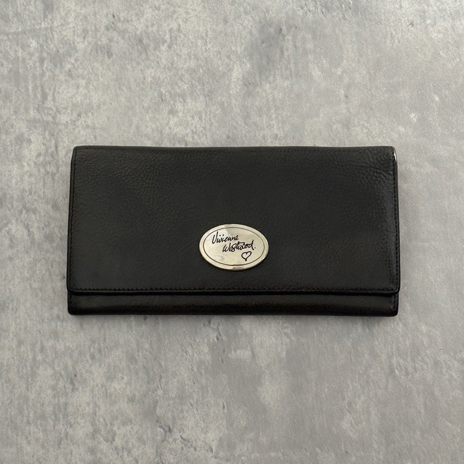 Vivienne Westwood Icon Signature Long Wallet in black leather, featuring logo plaque, multiple card slots and zip compartment interior, snap button closure, vintage condition.