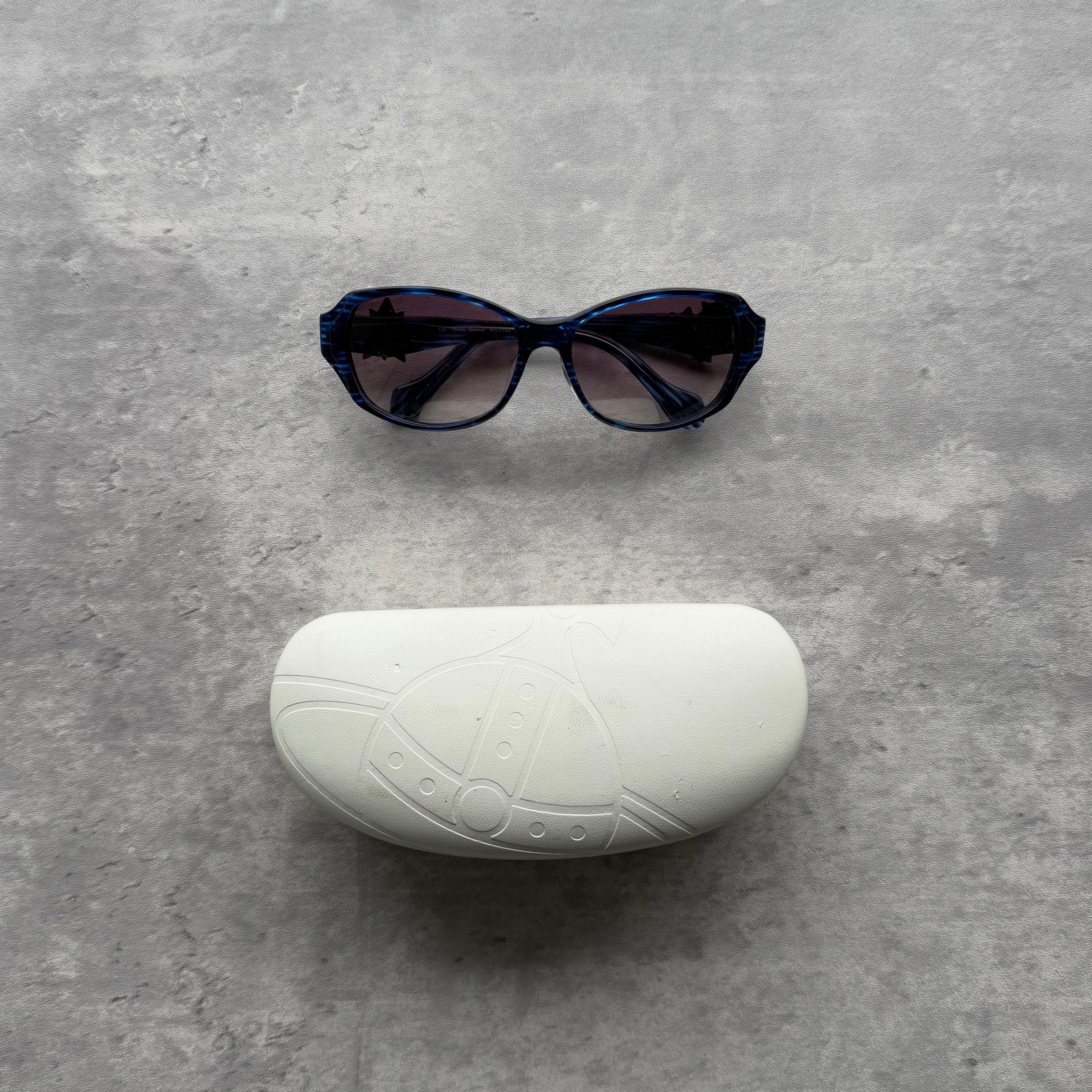 Vivienne Westwood Rockstar Sunglasses in blue acetate frame with pink enamel Orb and heart accents, gradient lenses, and original case.