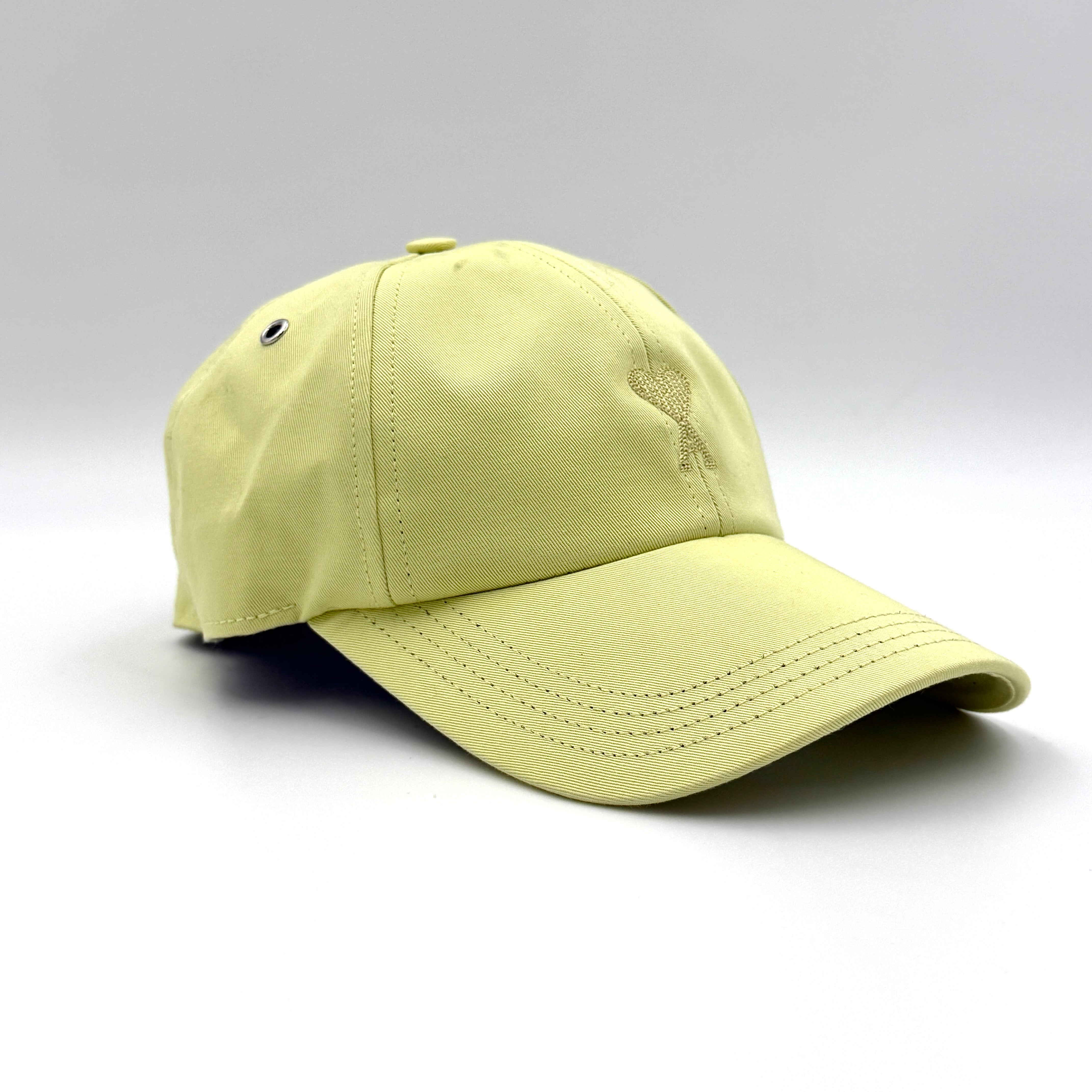 Ami Paris Ami de Coeur baseball cap in yellow cotton featuring embroidered heart logo and adjustable strap.
