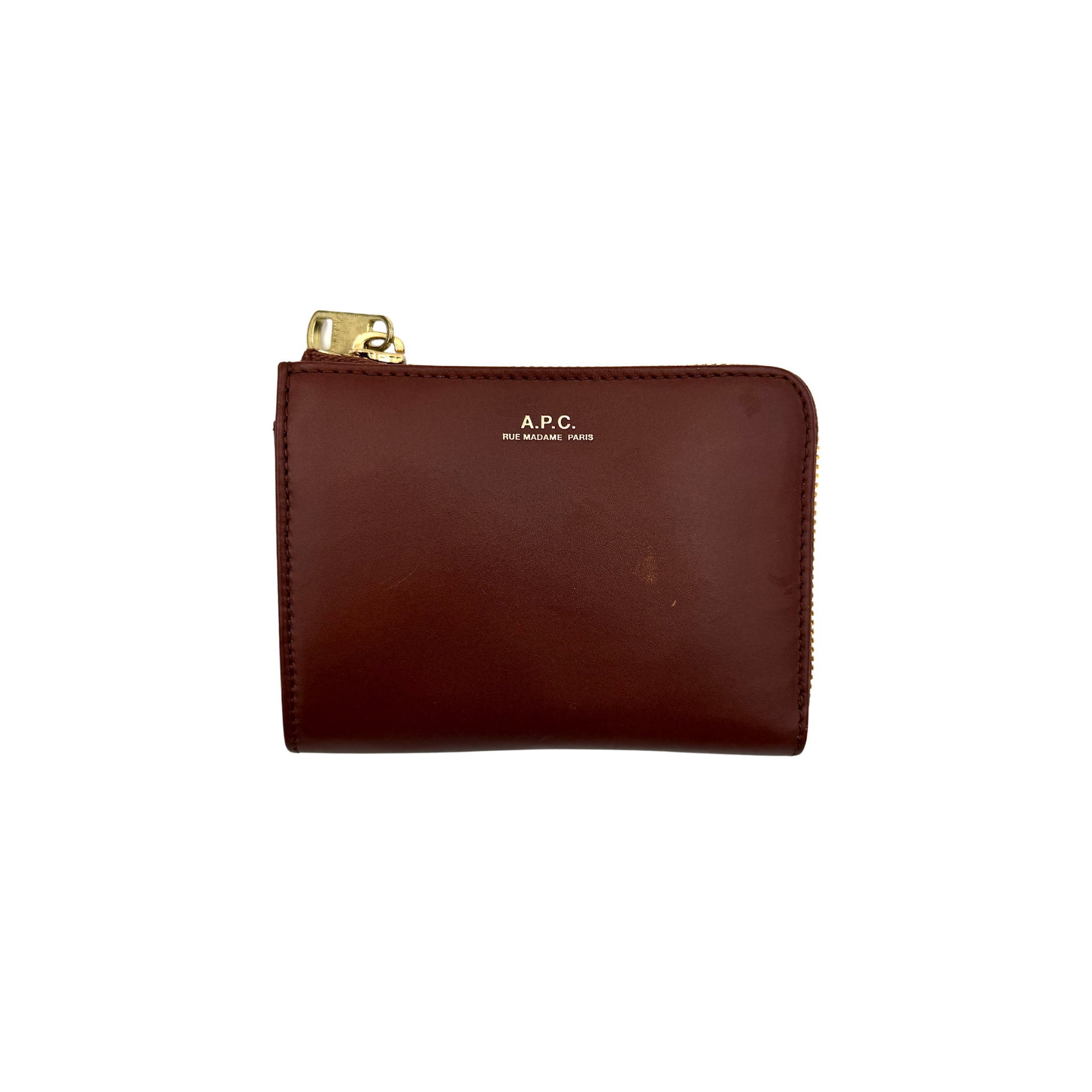 A.P.C Lise compact wallet in brown leather featuring a minimalist design with top zip closure, shown with A.P.C dust bag and tag.