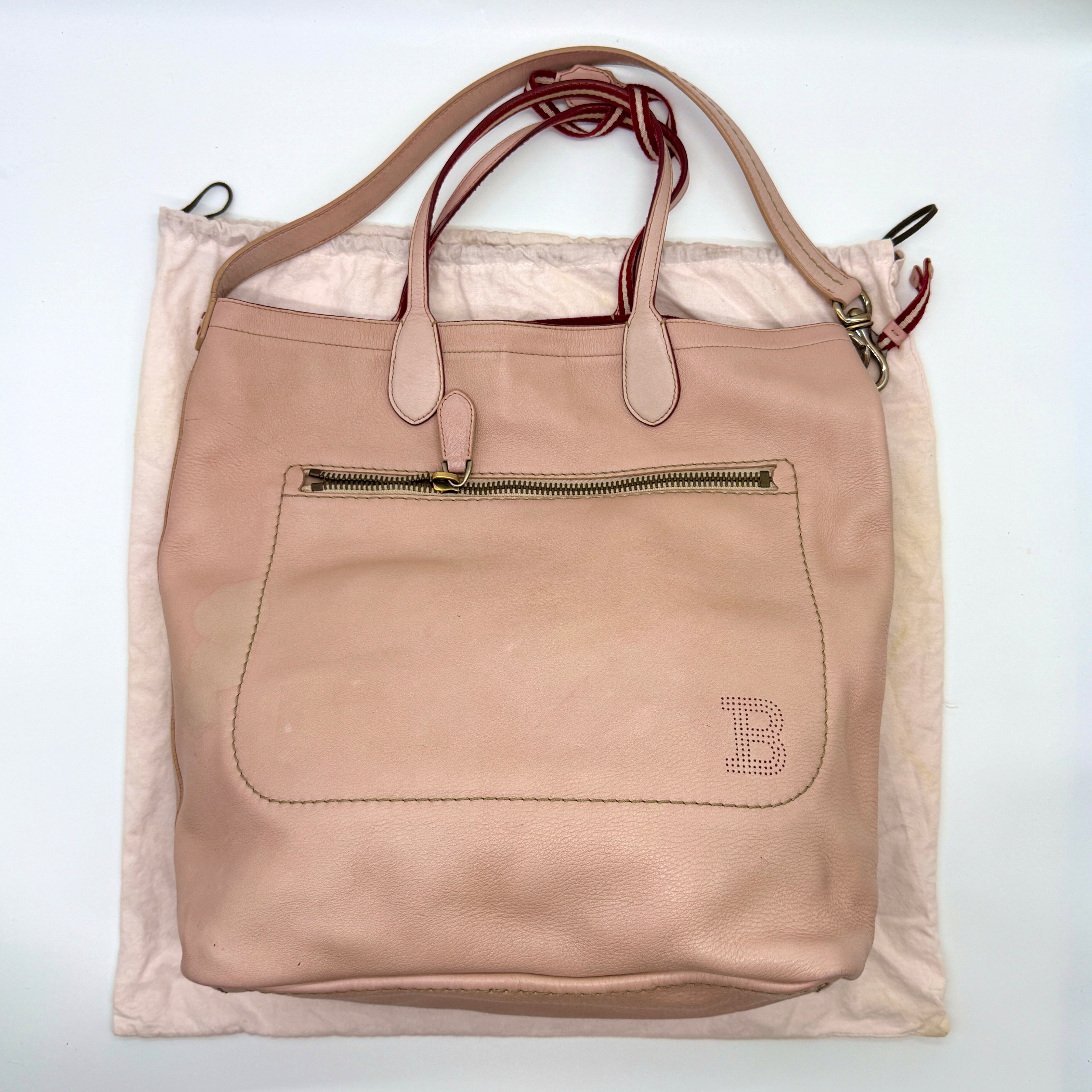 Bally Leather Tote Bag in blush pink leather with red suede interior, perforated B logo, and front zip pocket.