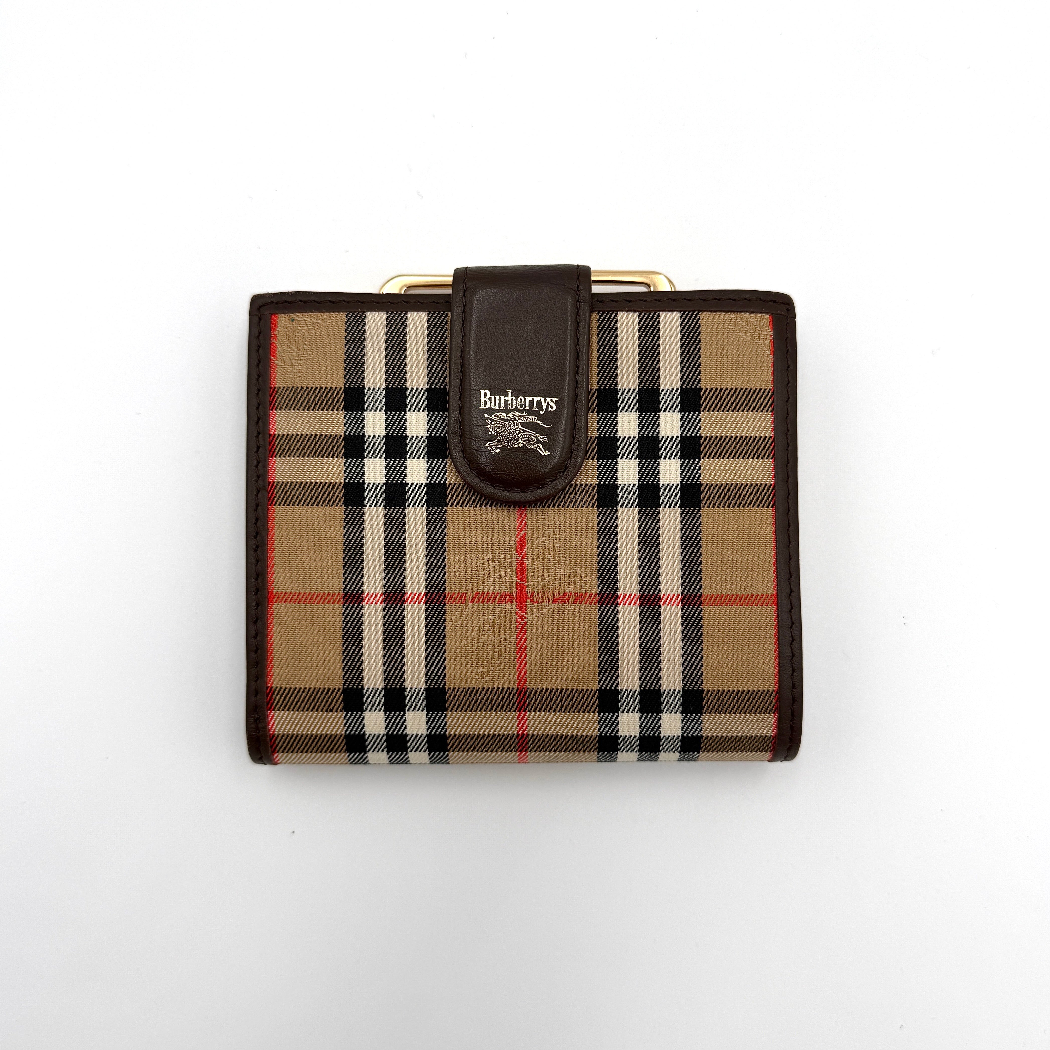 Burberry Nova Check Kisslock Wallet featuring classic Nova Check pattern, brown leather trim, and kisslock closure, open to reveal interior compartments.