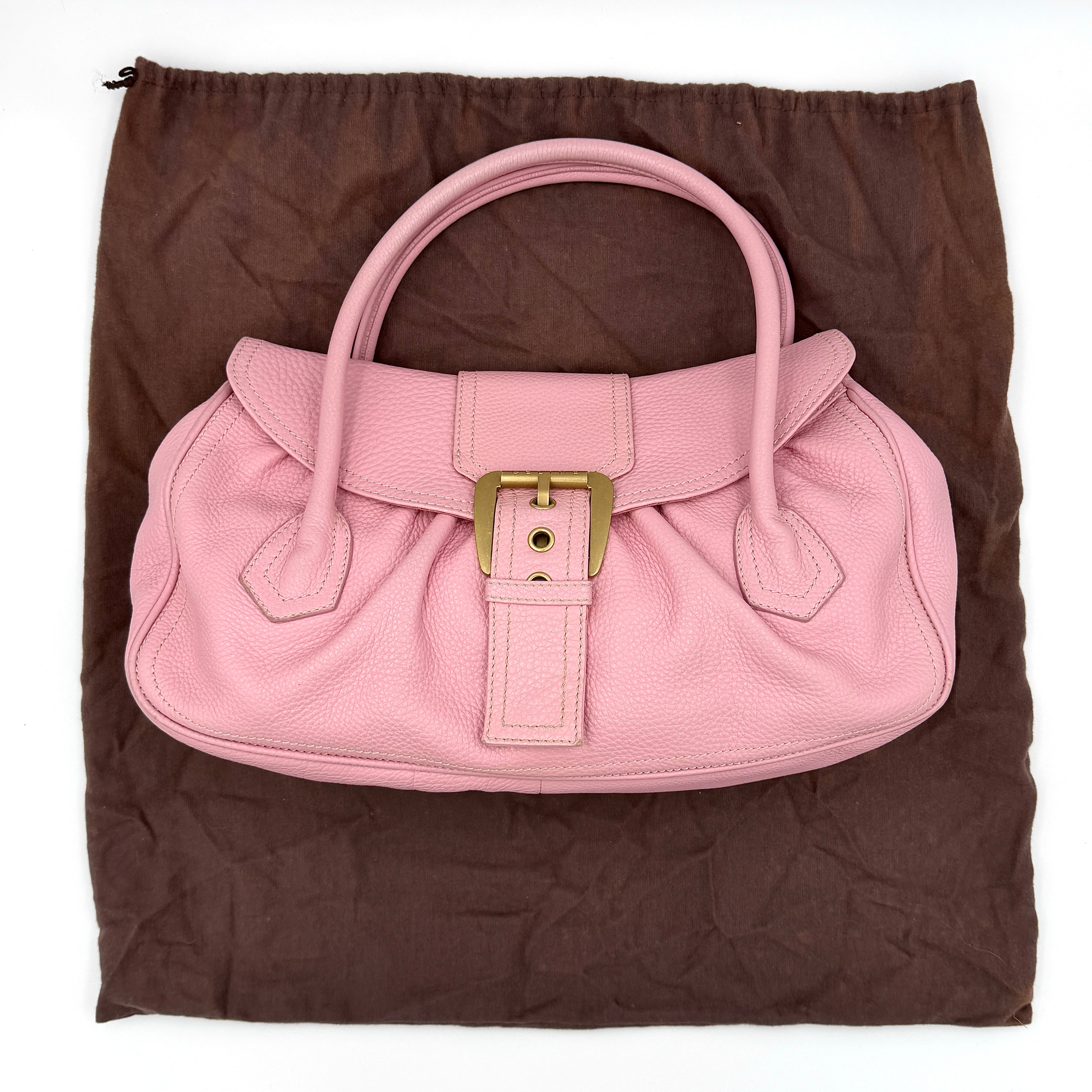 Celine Y2K bubblegum pink shoulder bag crafted from grained leather with gold-tone buckle closure and top handle.