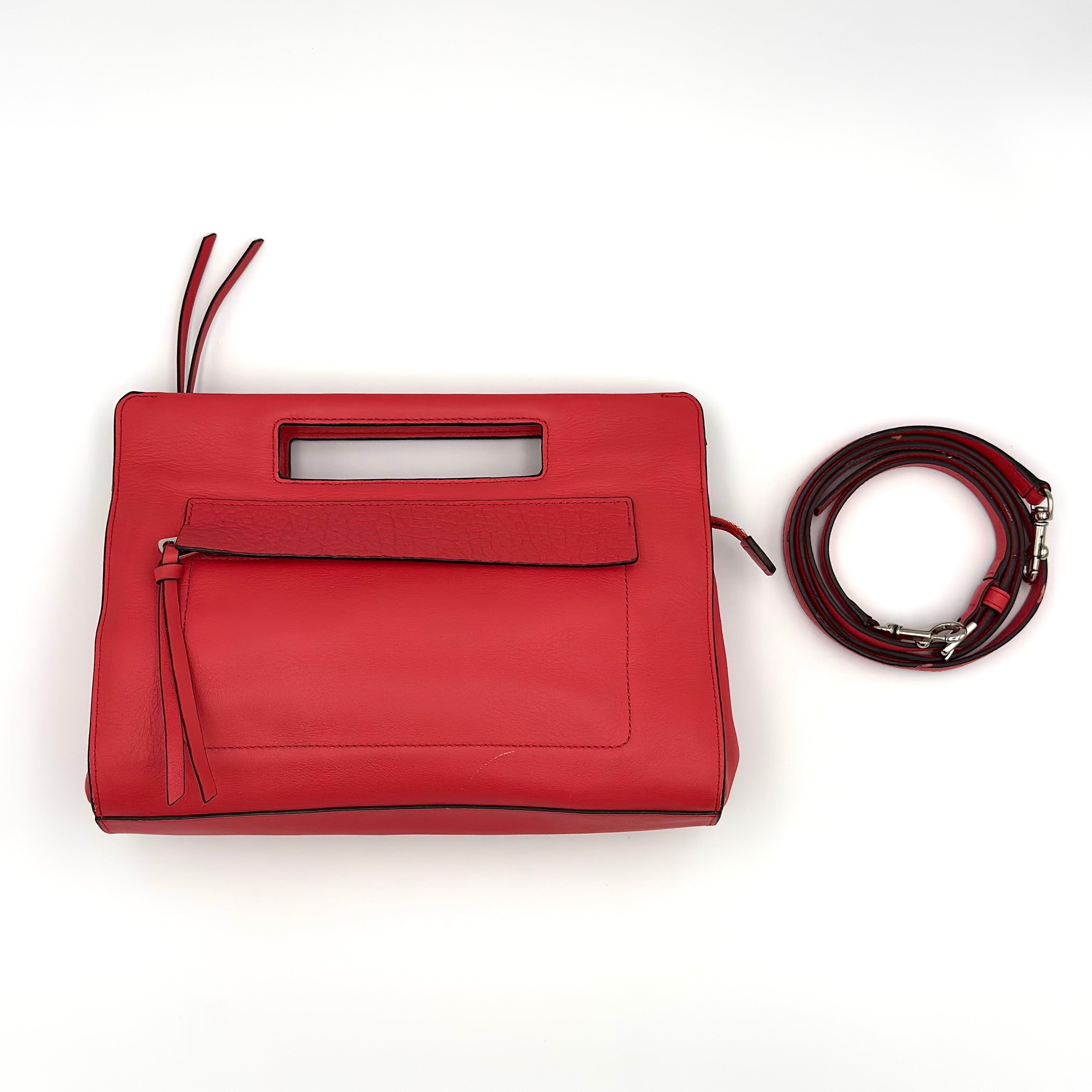 Coach 2Way Bleecker Pocket Clutch Bag in red smooth leather with cutout handle, detachable strap, and beige interior.
