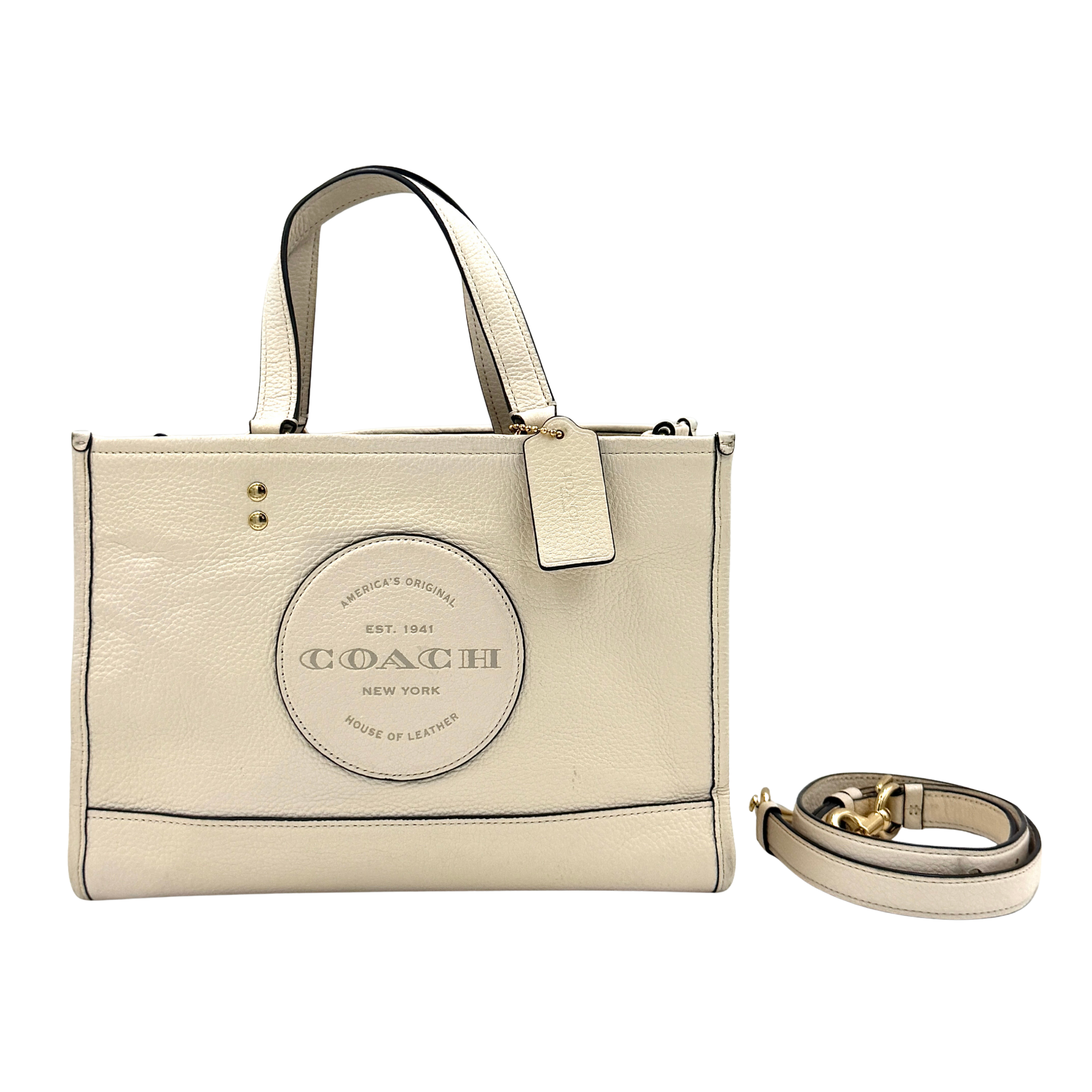 Coach Dempsey 22 Carryall Tote Bag in white with structured silhouette, dual carrying options, and Coach emblem detail