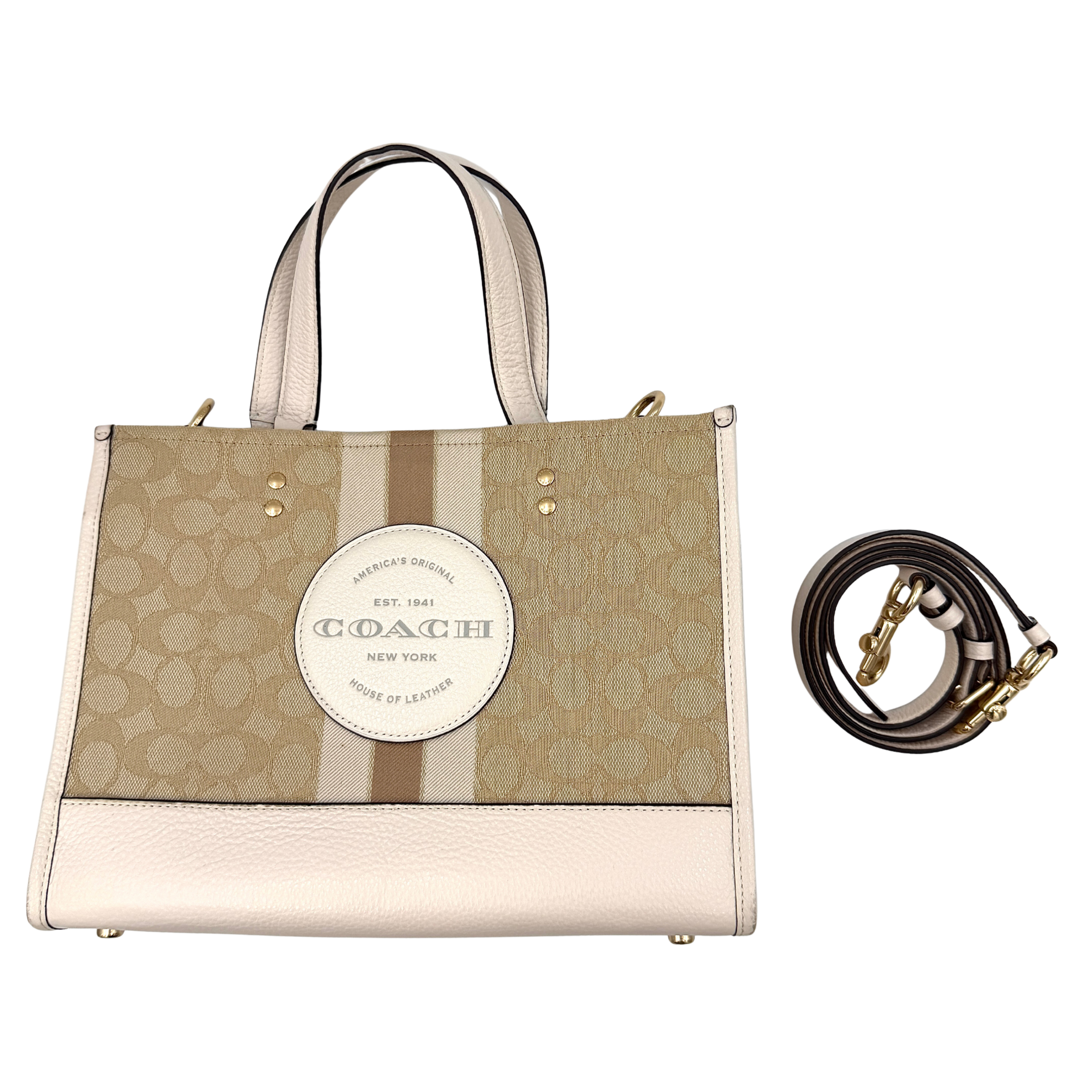 Coach Dempsey Carryall 22 Tote Bag in beige with signature pattern, contrast stripe, dual handles, and detachable strap.