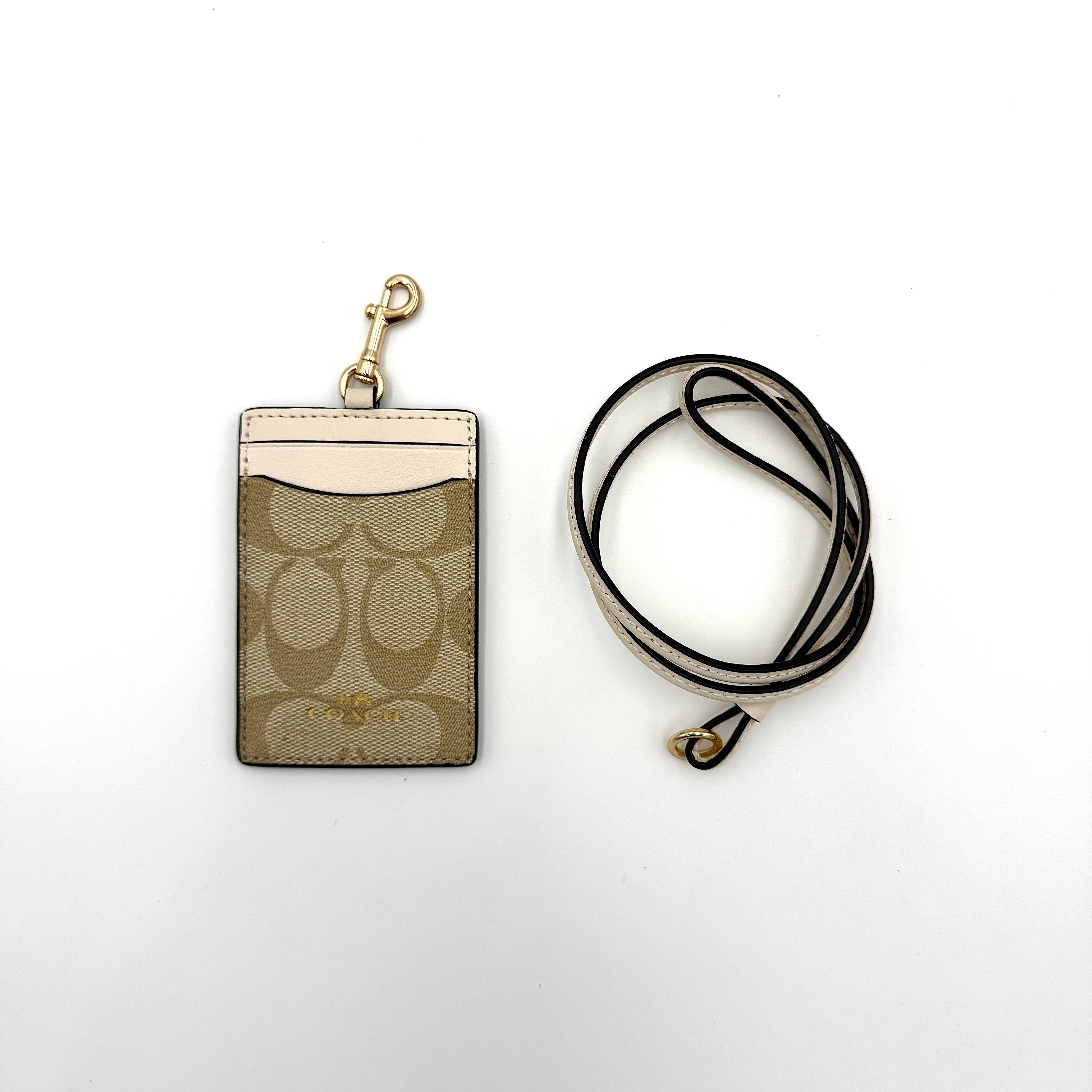Coach yellow mini skinny ID case cardholder featuring a ring attachment, zippered compartment, and exterior ID window.