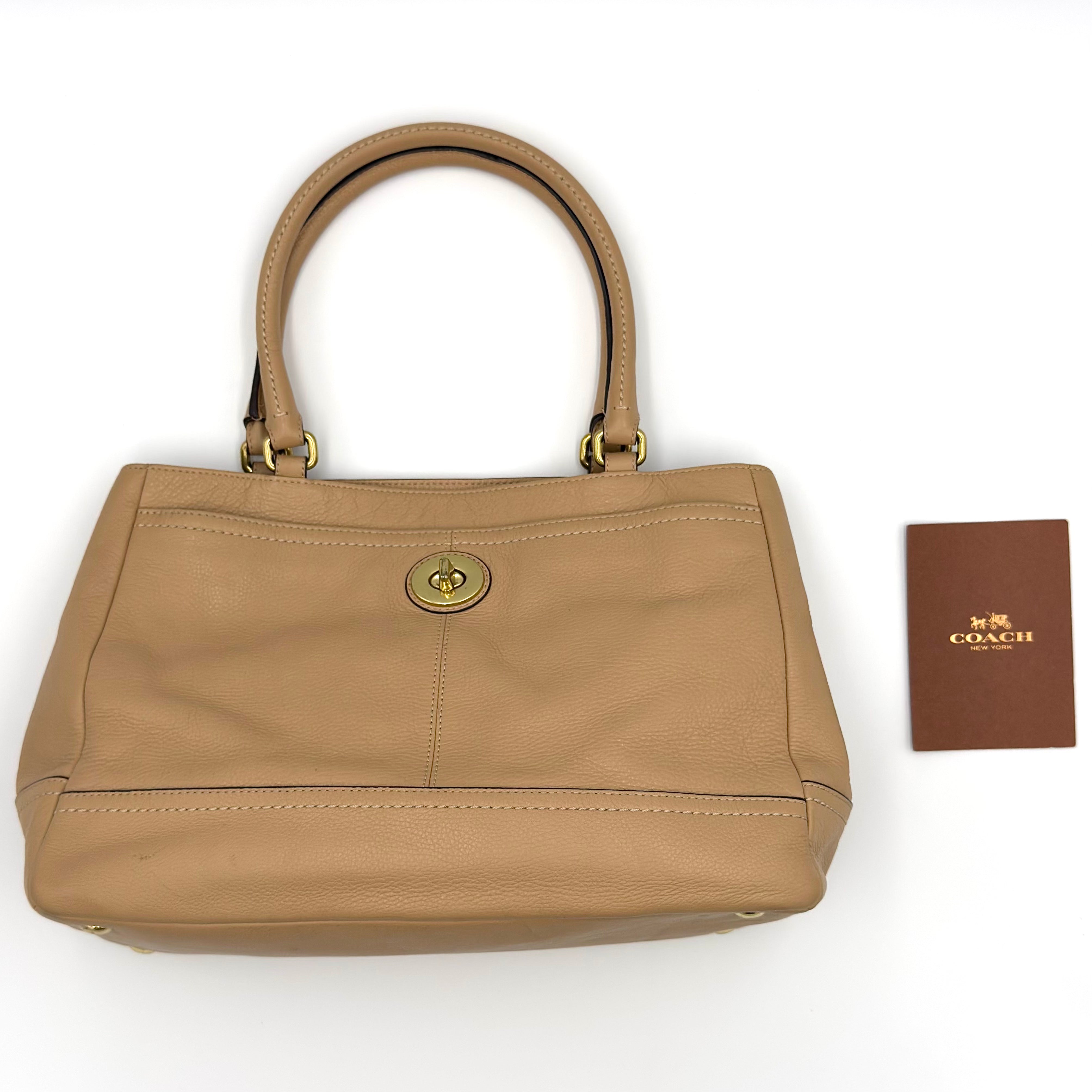 Coach Park Carryall Shoulder Bag in brown leather with gold-tone turn-lock detail, dual handles, and spacious multi-compartment interior.